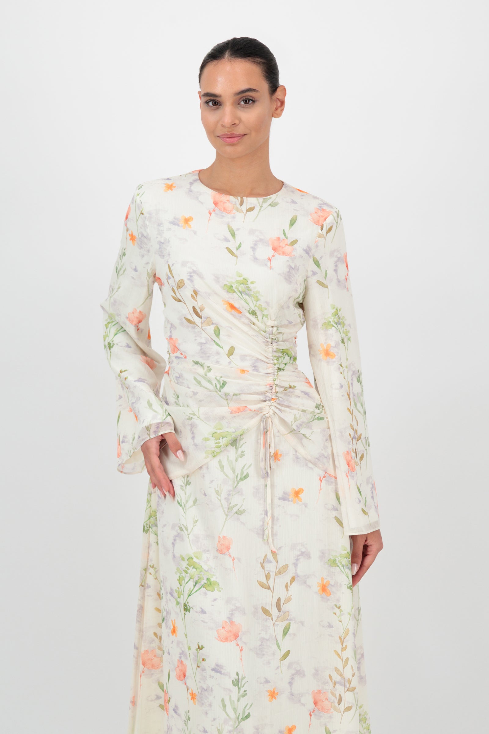 Angled front view of the FARES Scrunched Waist Chiffon Dress in Wildflower emphasizes the soft structure of this feminine long sleeve dress.