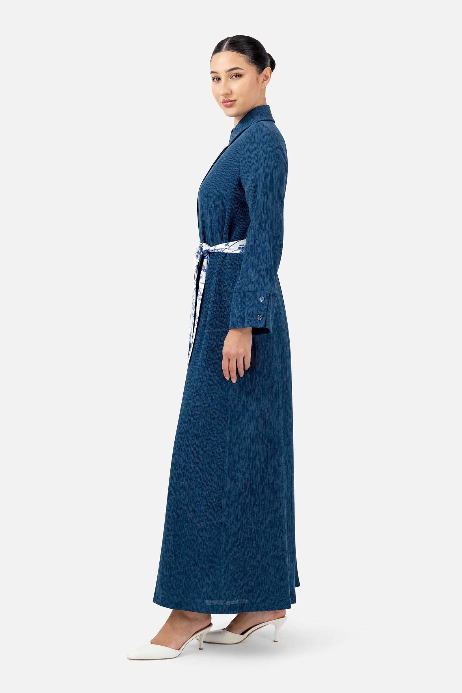 Side profile of the Indigo printed dress highlighting the relaxed silhouette and satin belt detail.