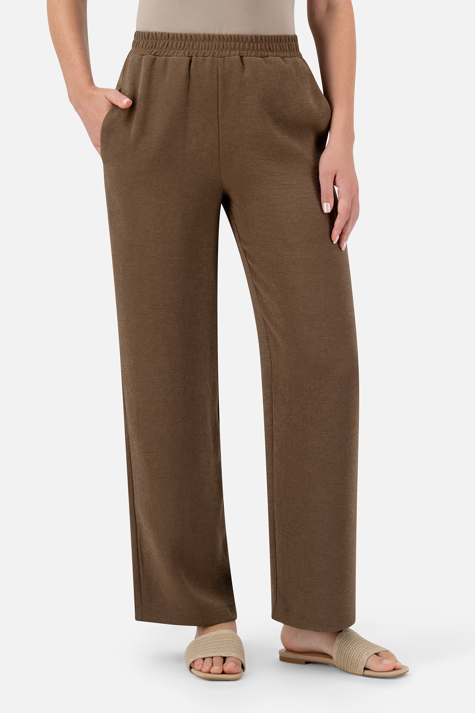 Woman standing in the Espresso relaxed fit pants.