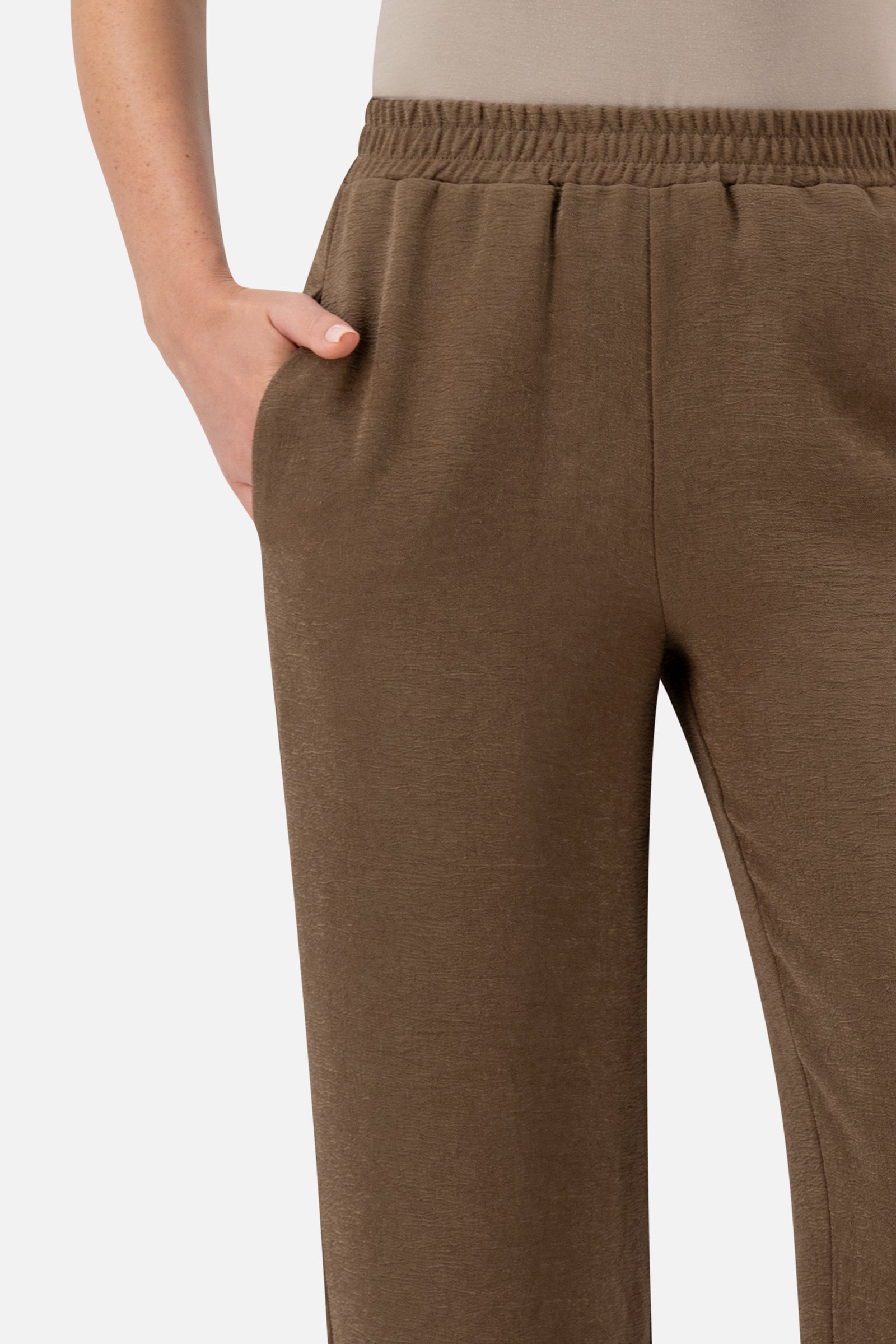 Close-up of the waistband and pocket detail on the Espresso relaxed fit pants.
