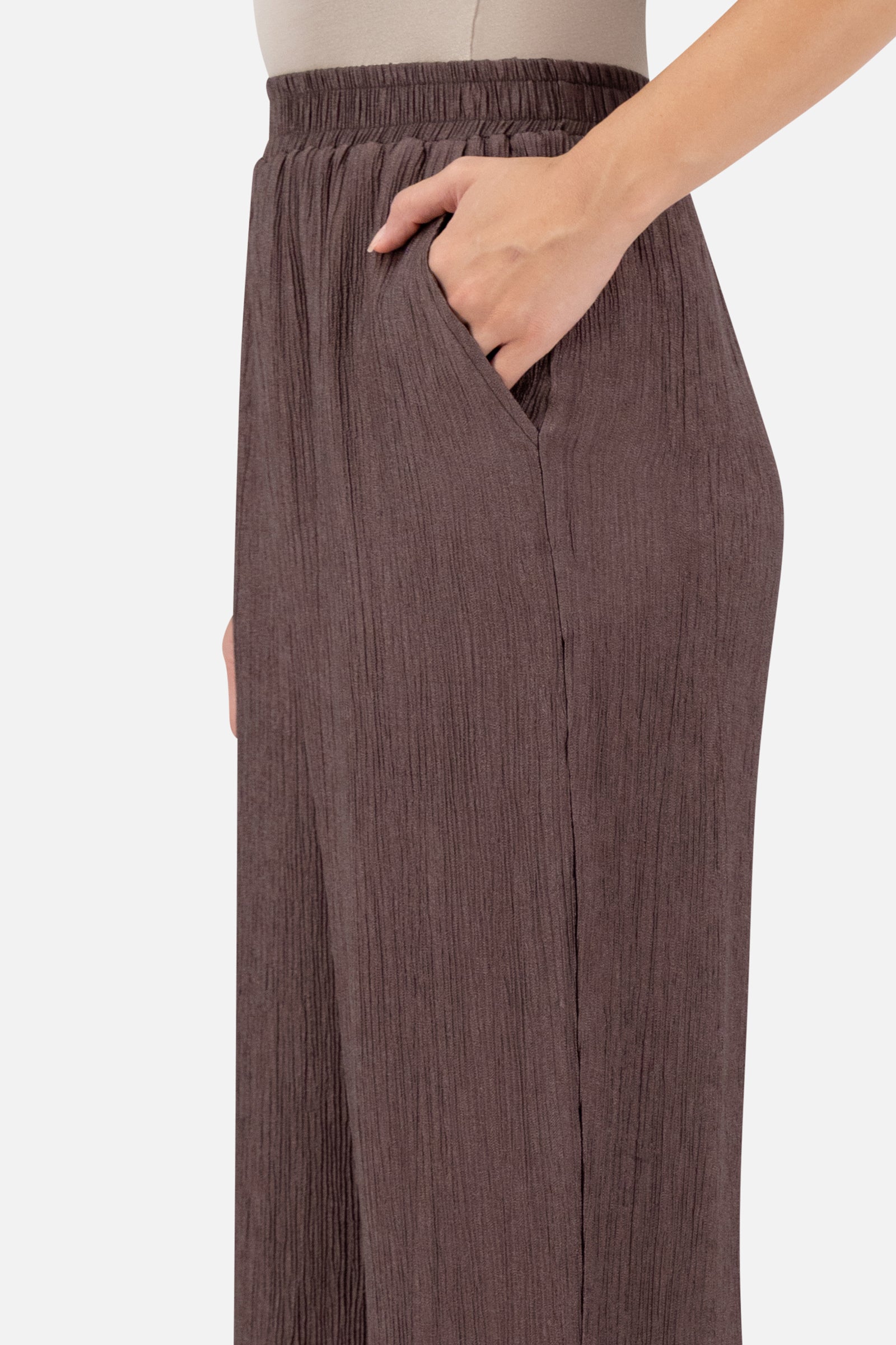 Close-up of the elastic waistband and rippled fabric detail on the Icy Brown relaxed fit pants.