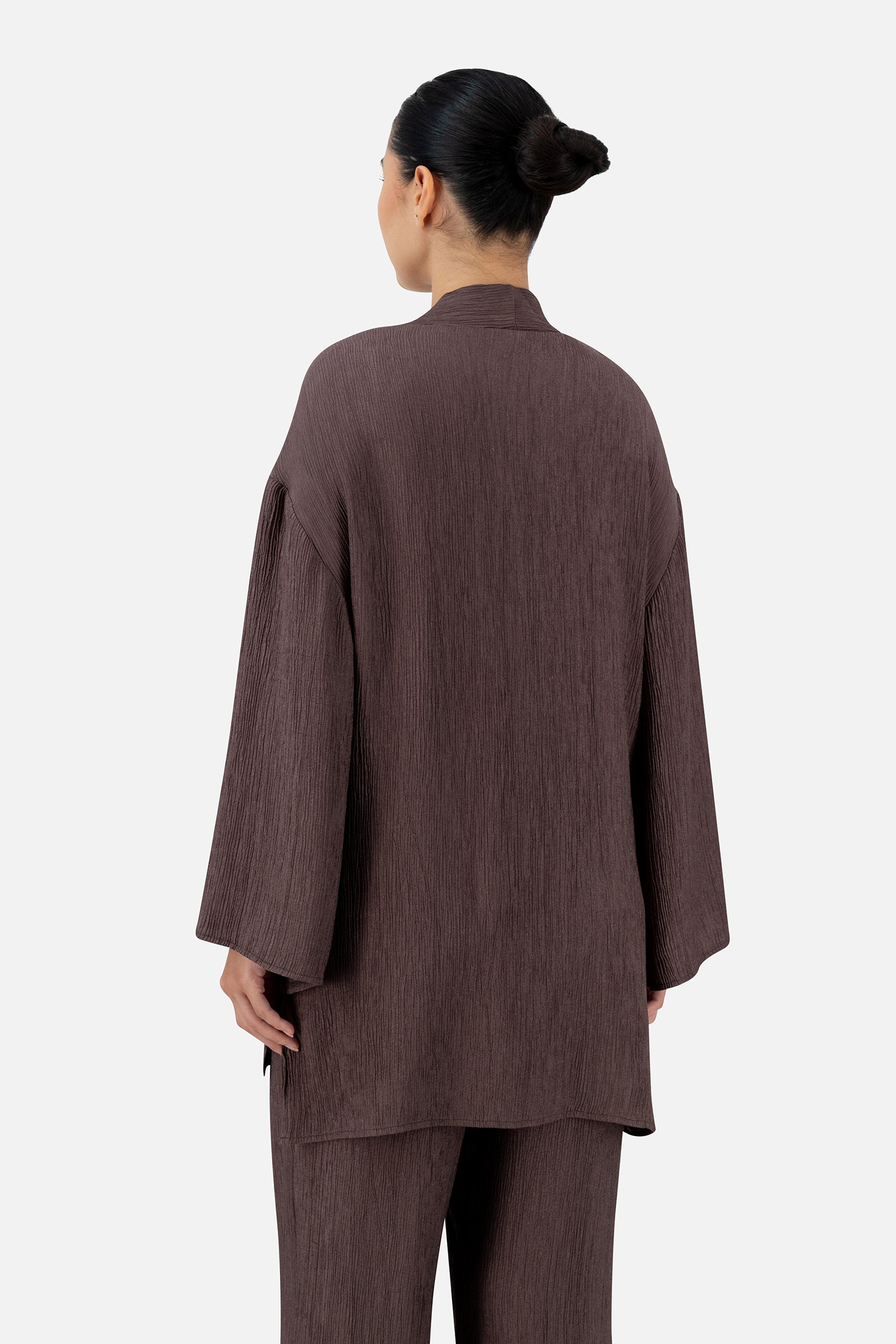Back view of the Icy Brown bow cardigan showcasing the loose fit and wide sleeves.
