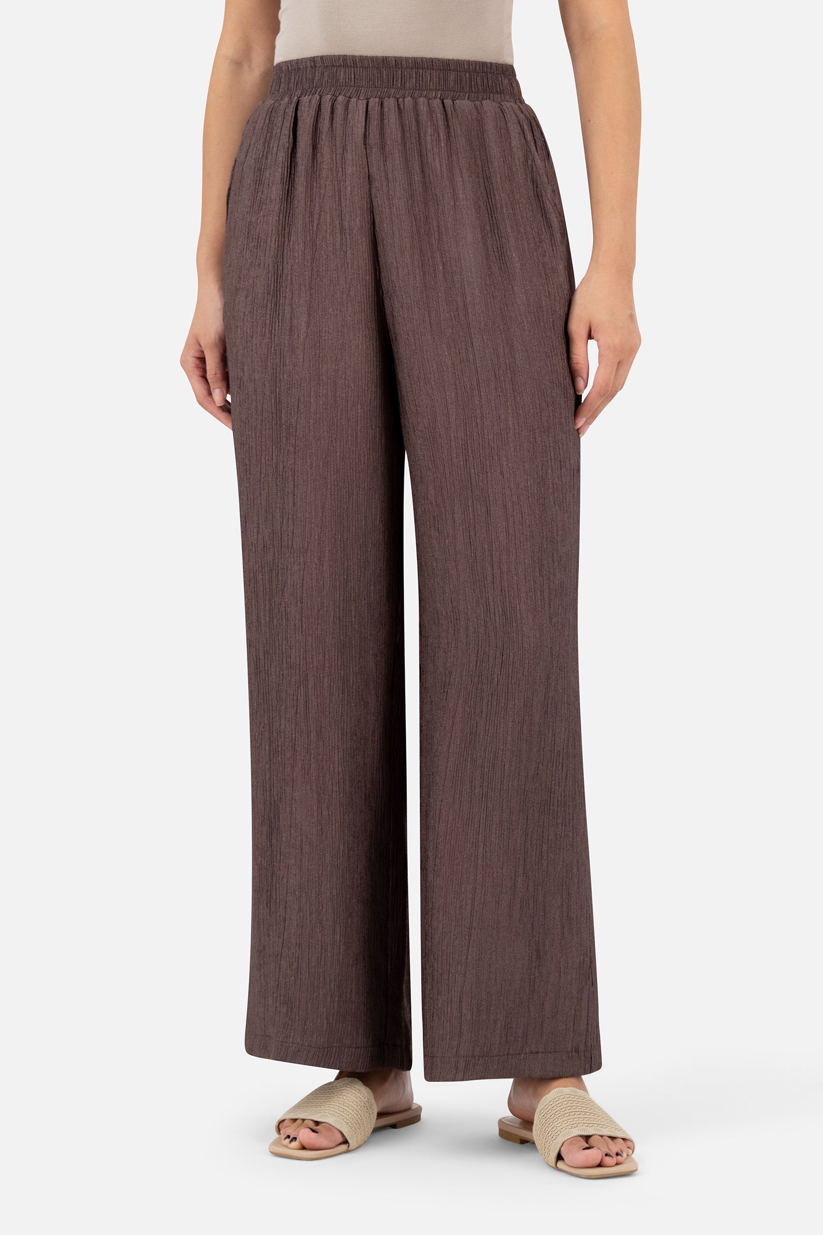 Woman wearing the Icy Brown rippled relaxed fit pants, front view with a wide-leg silhouette.