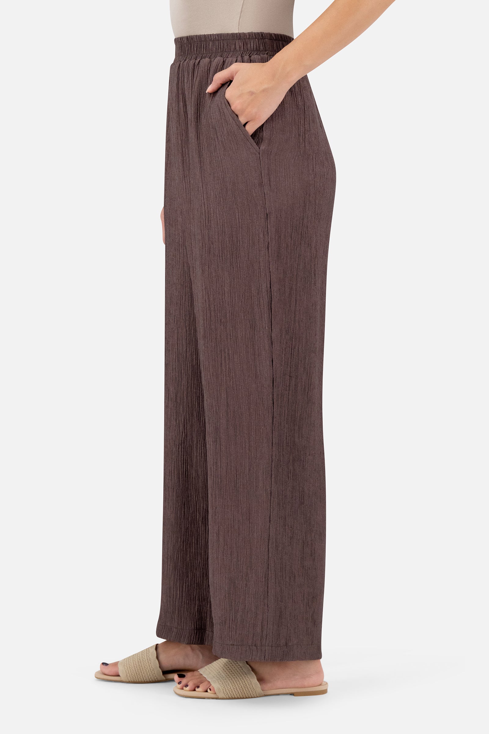 Side profile of the Icy Brown pants for women highlighting the flowing wide-leg design.