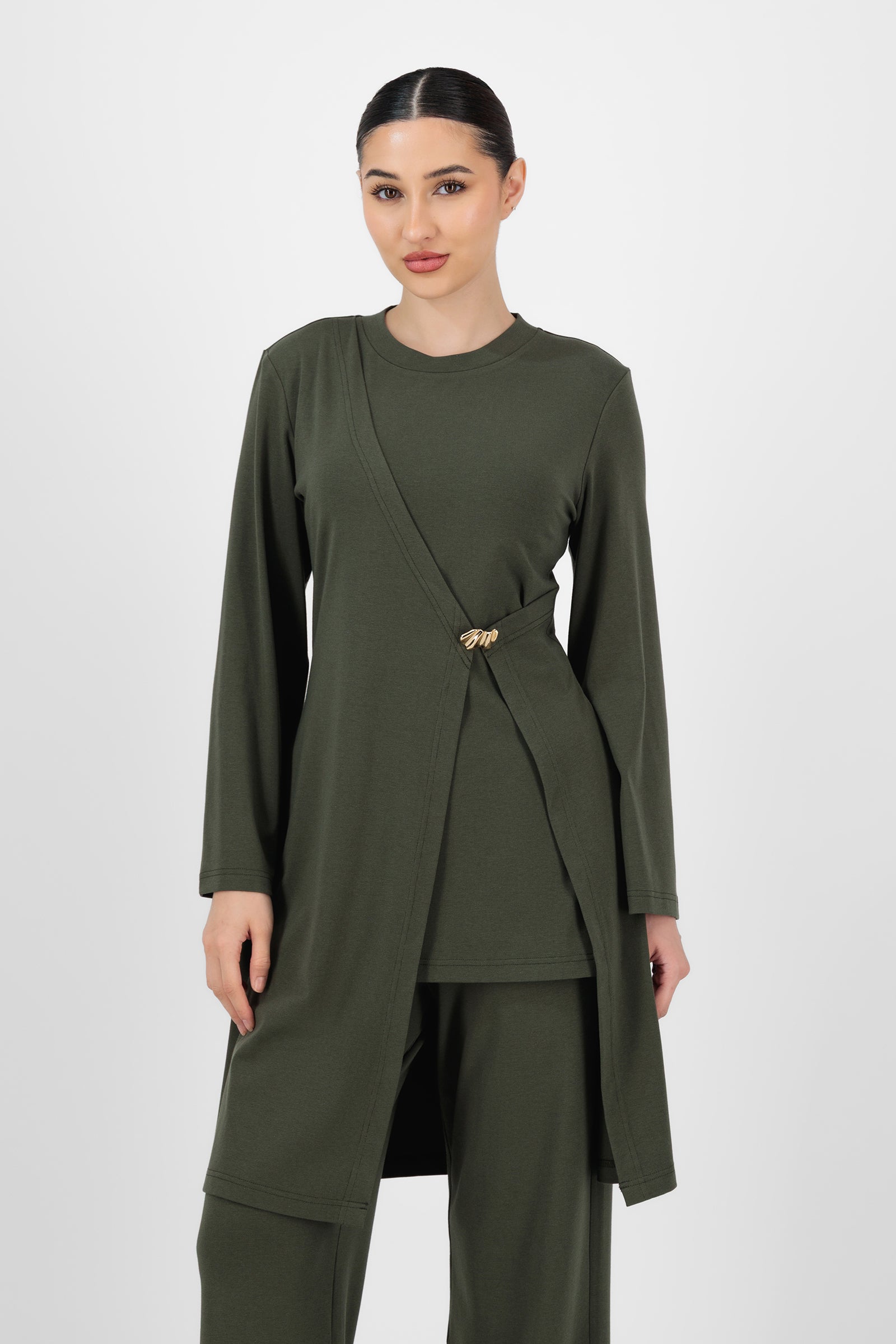 Model wearing the Gold Accent Wrap Top in Evergreen front view, highlighting the flattering wrap silhouette and subtle gold detail that elevate this long sleeve wrap top.