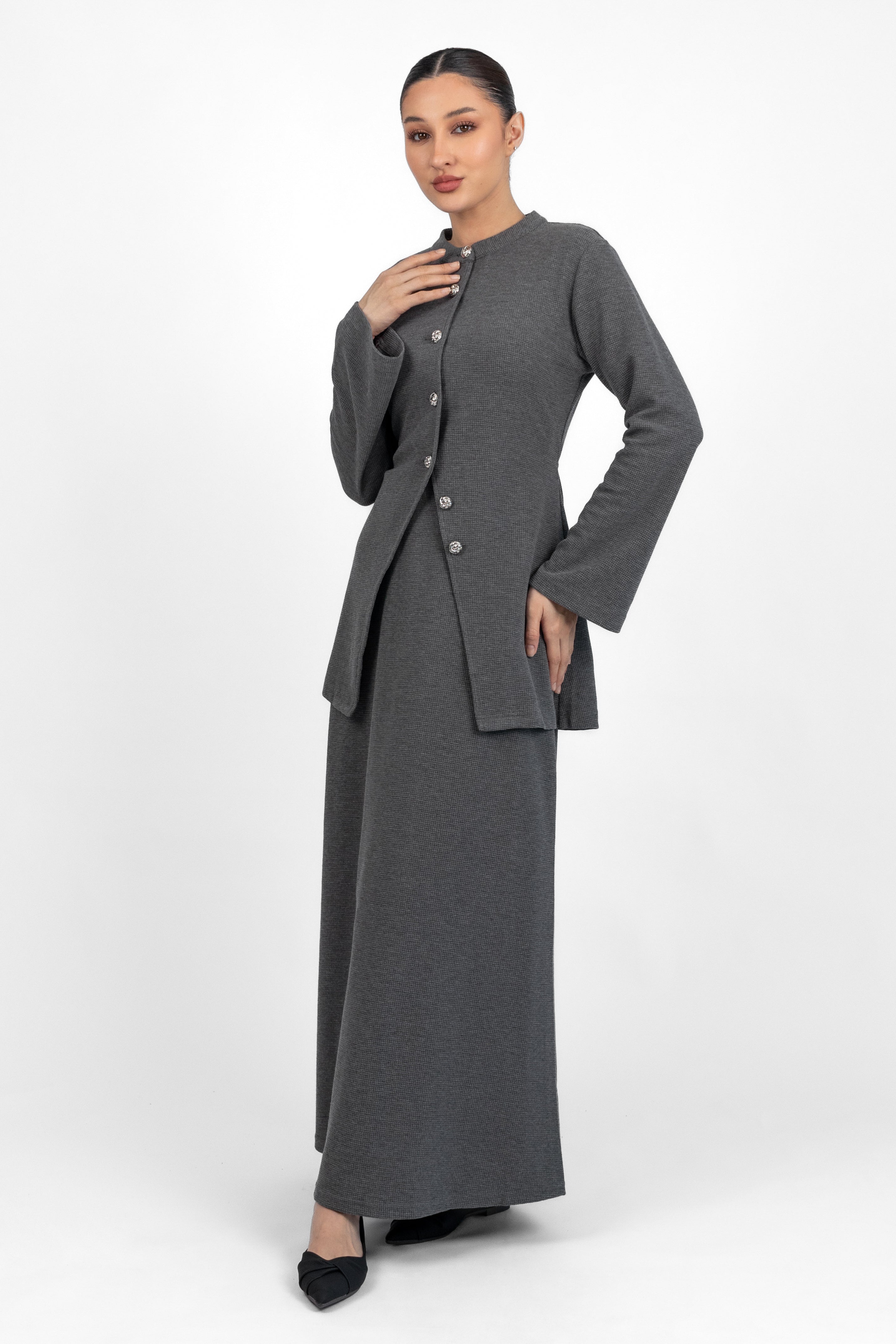 A woman is looking in the camera wearing a Tailored Vintage Cardigan.