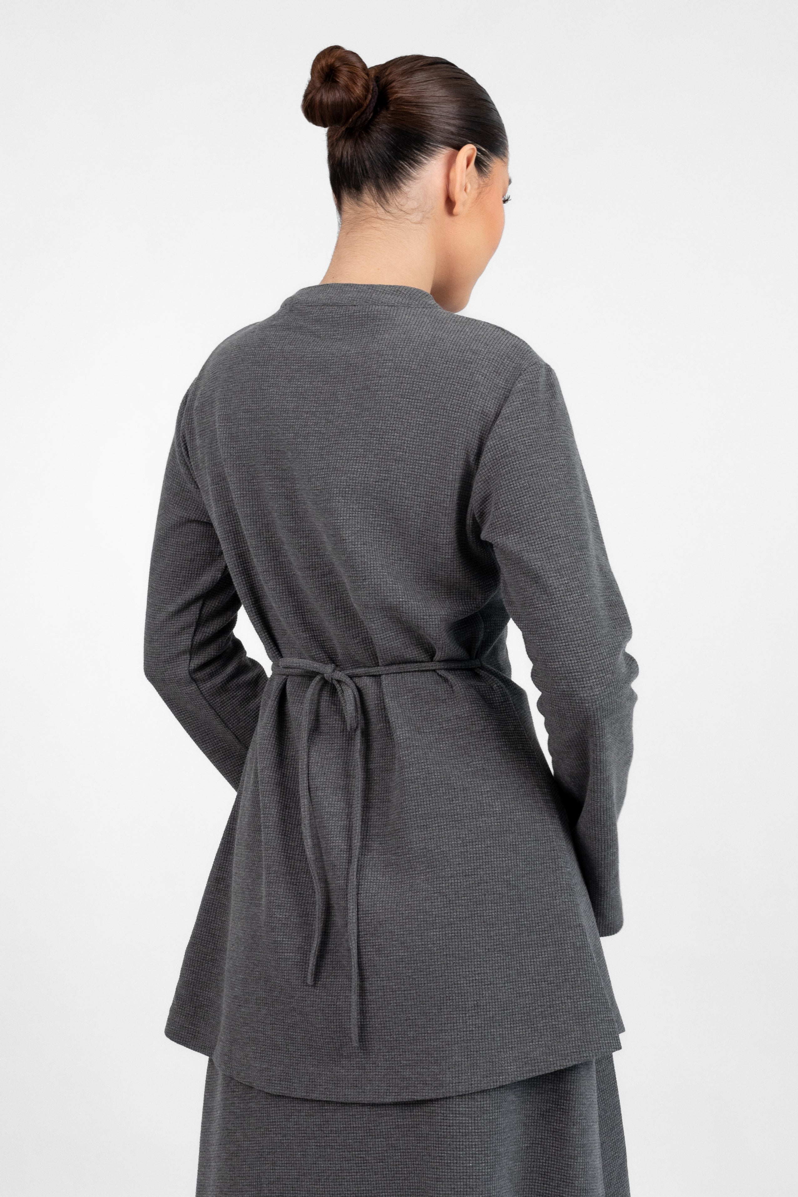 A back pose in a Tailored Vintage Cardigan.