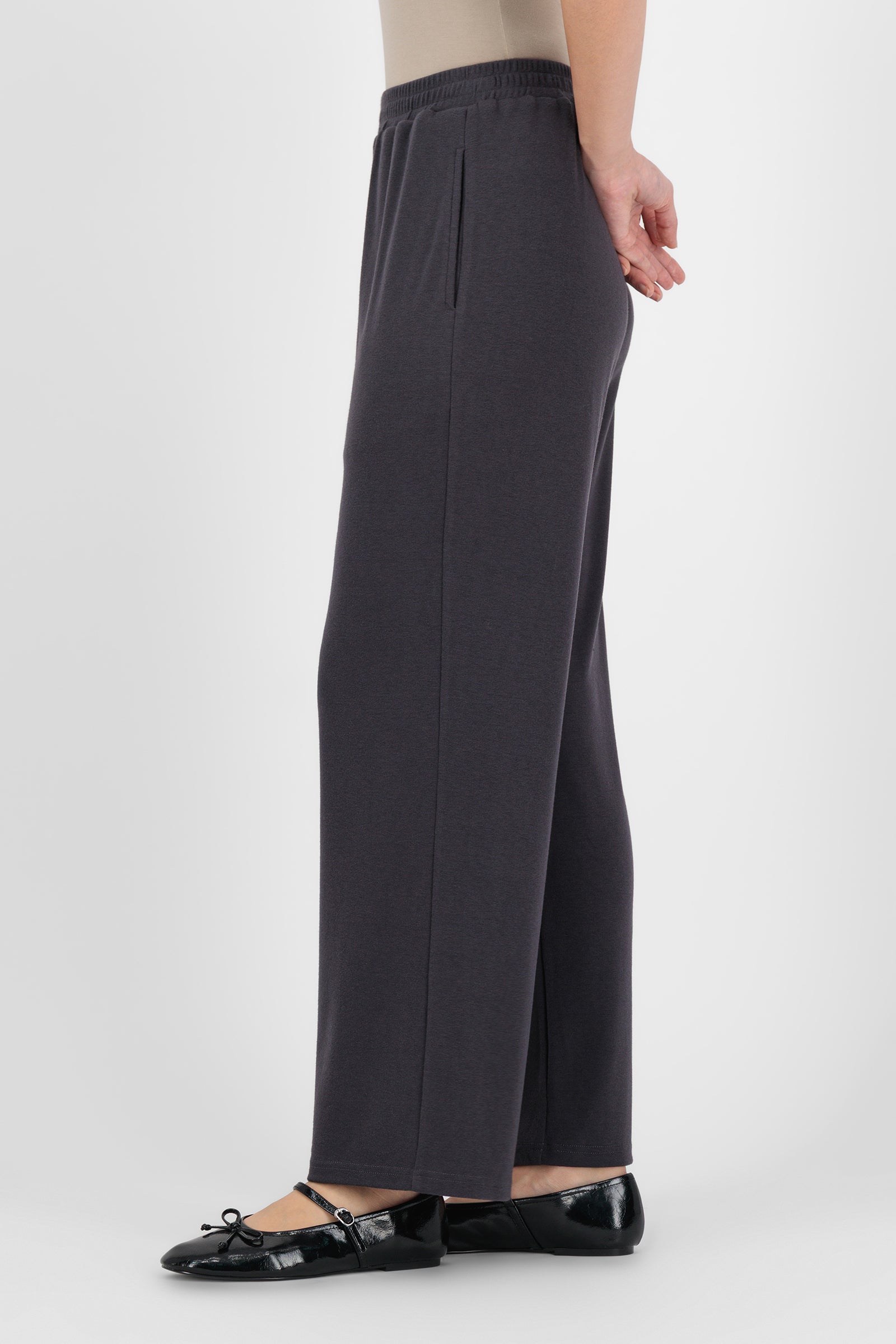 Side angle of the Straight Leg Knit Pants in Charcoal capturing the soft drape and streamlined leg shape that balance comfort with the structure of straight leg pants.