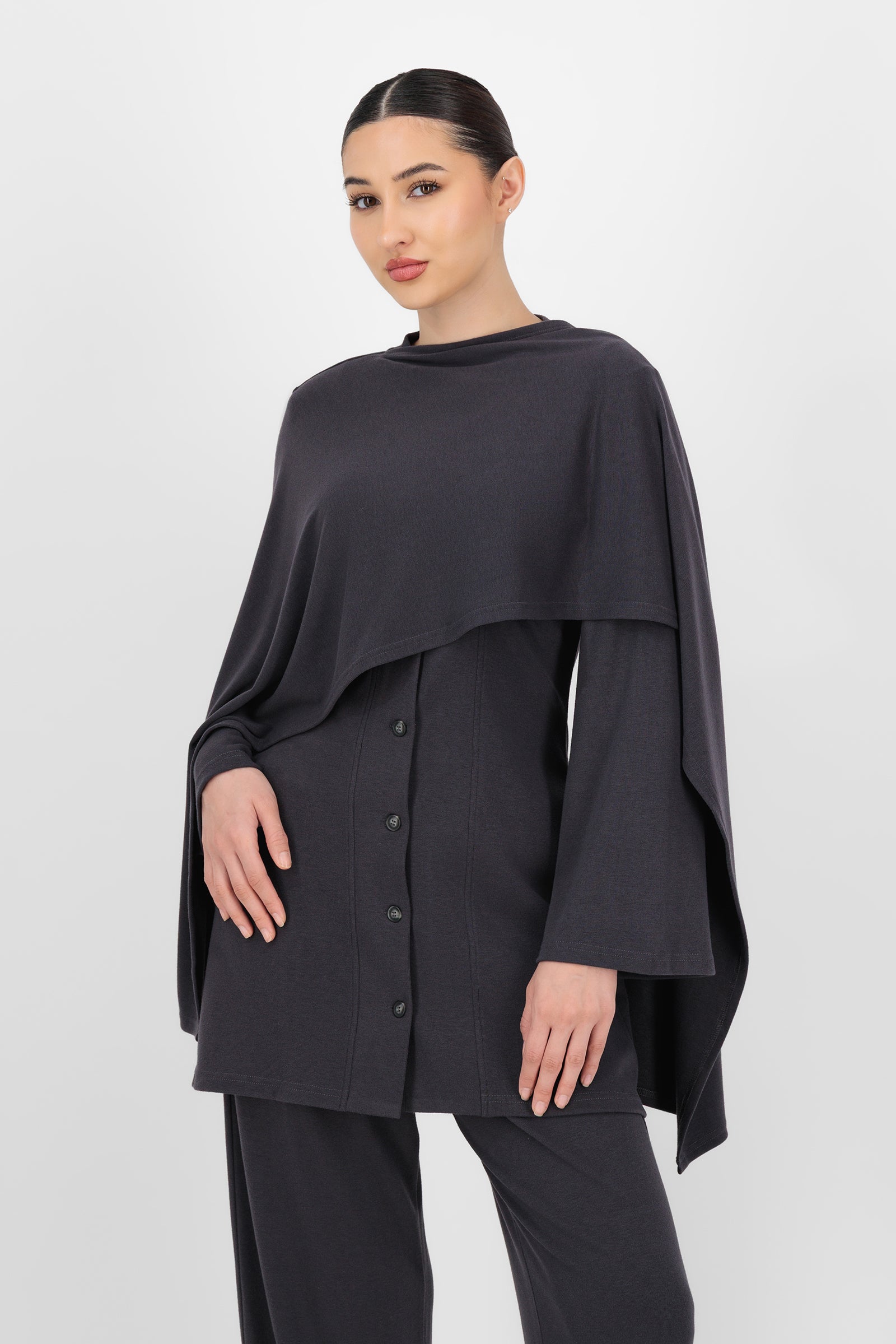 Model wearing the Draped Shawl Knit Top in Charcoal front view, showing the soft shawl neckline and elegant drape that make it a standout piece among knit tops and everyday tops for women.