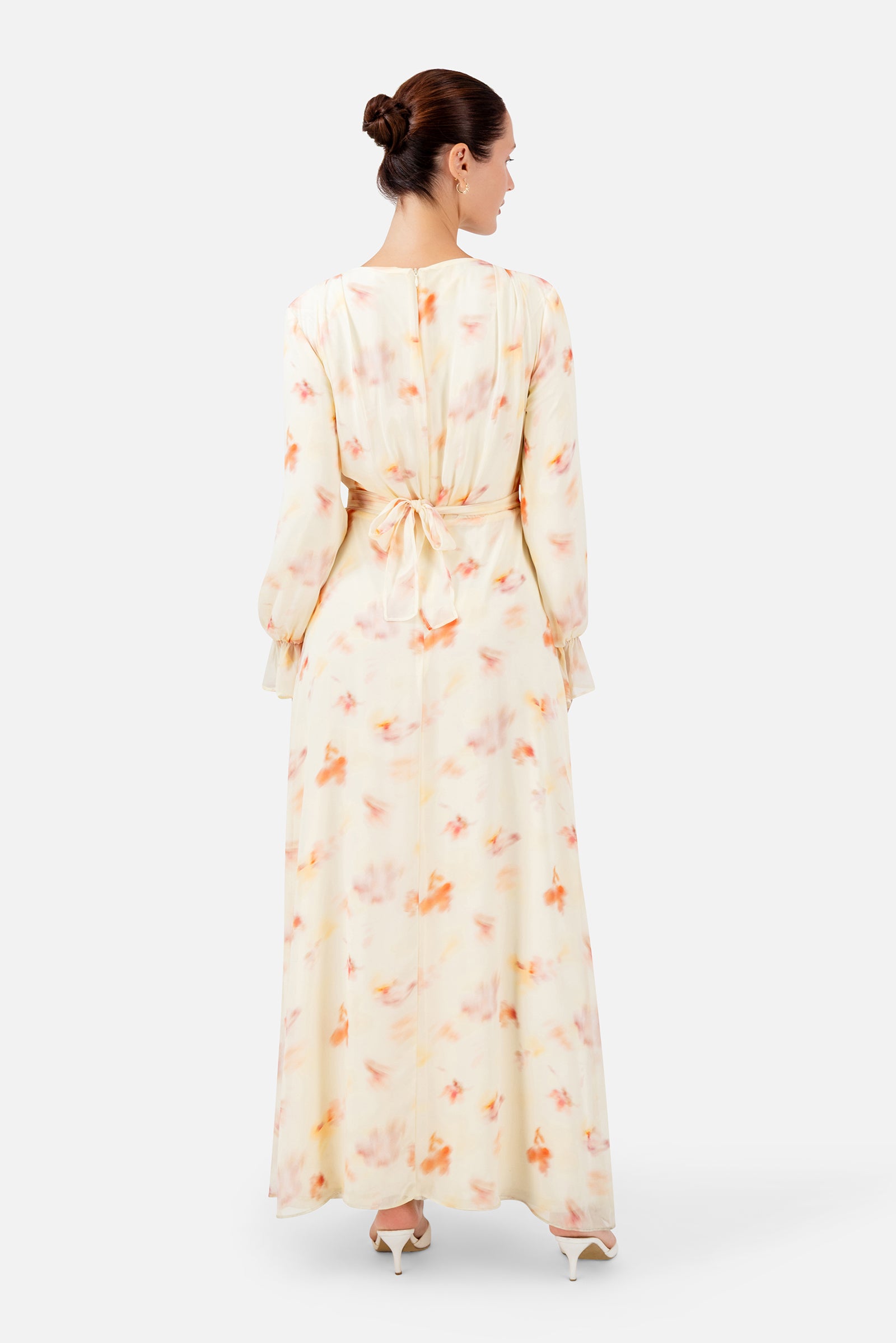 FARES Waist Wrap Chiffon Dress in Sunbloom shown from the back, highlighting the flowing full-length silhouette and soft floral print.