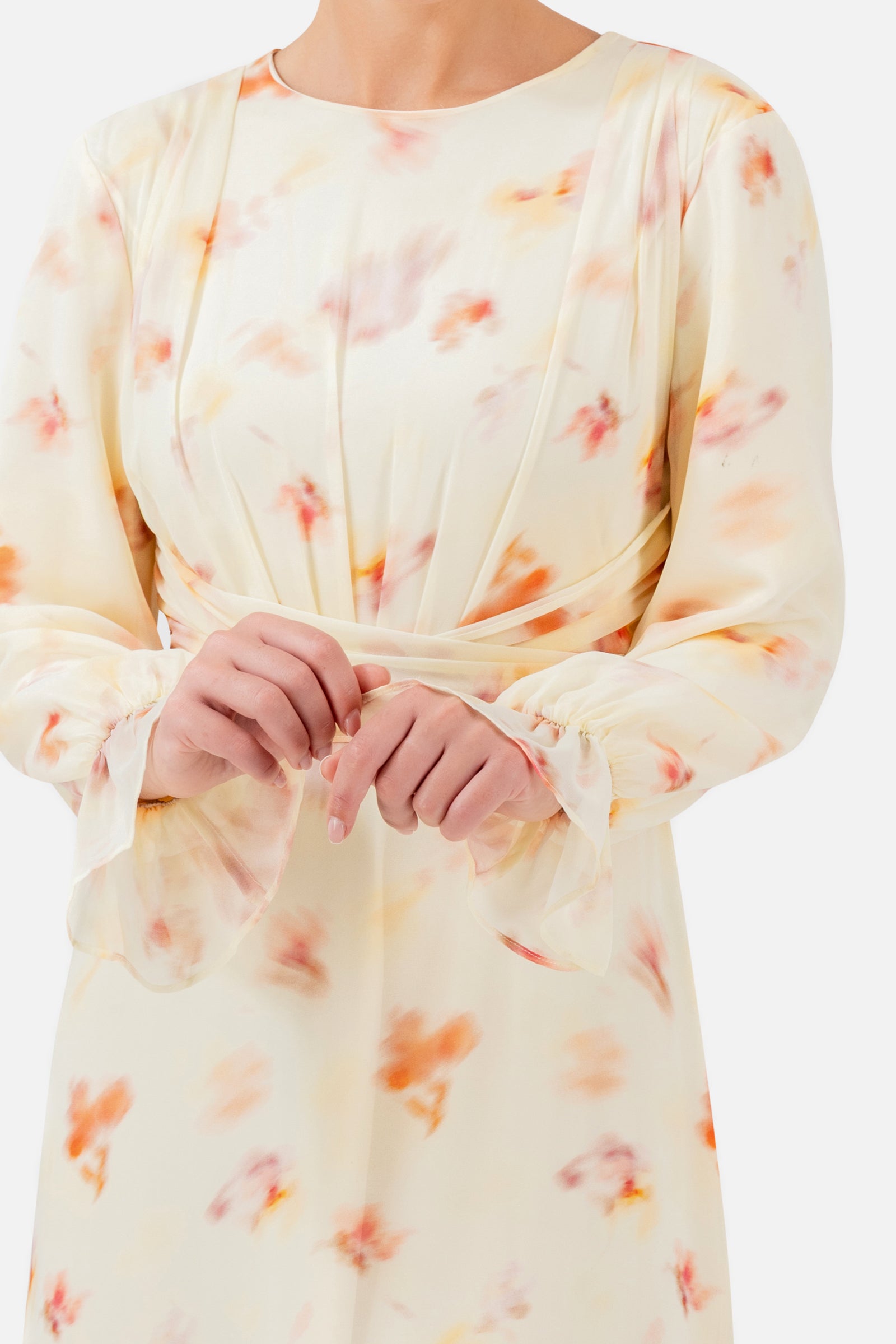 Closer view of the FARES Waist Wrap Chiffon Dress in Sunbloom, highlighting the delicate floral print, long sleeves and wrap waist.