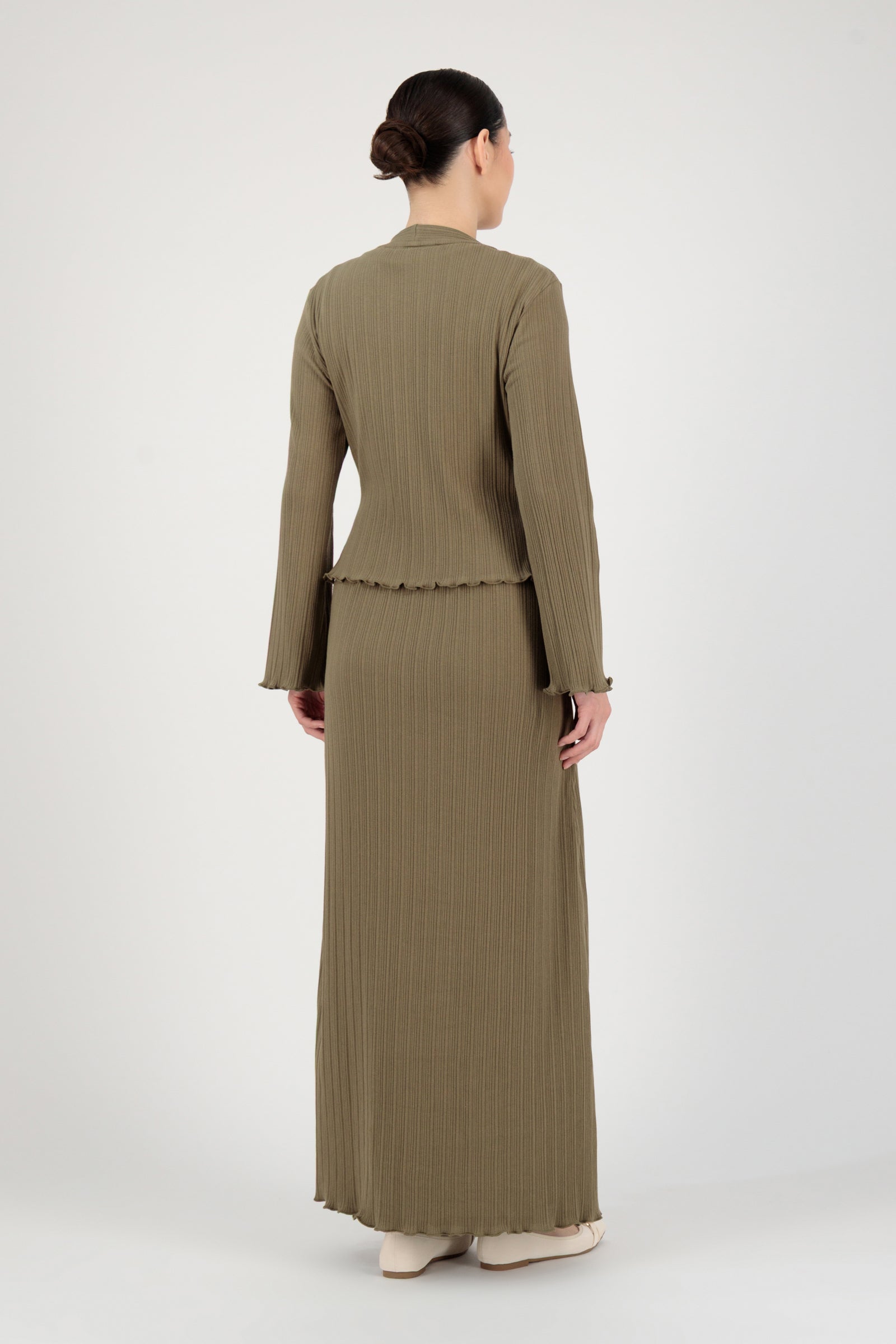 Back view of the FARES Ribbed Cotton Dress and Cardigan in Grove highlighting the clean fall of the long sleeve dress and the soft structure of the cardigan.
