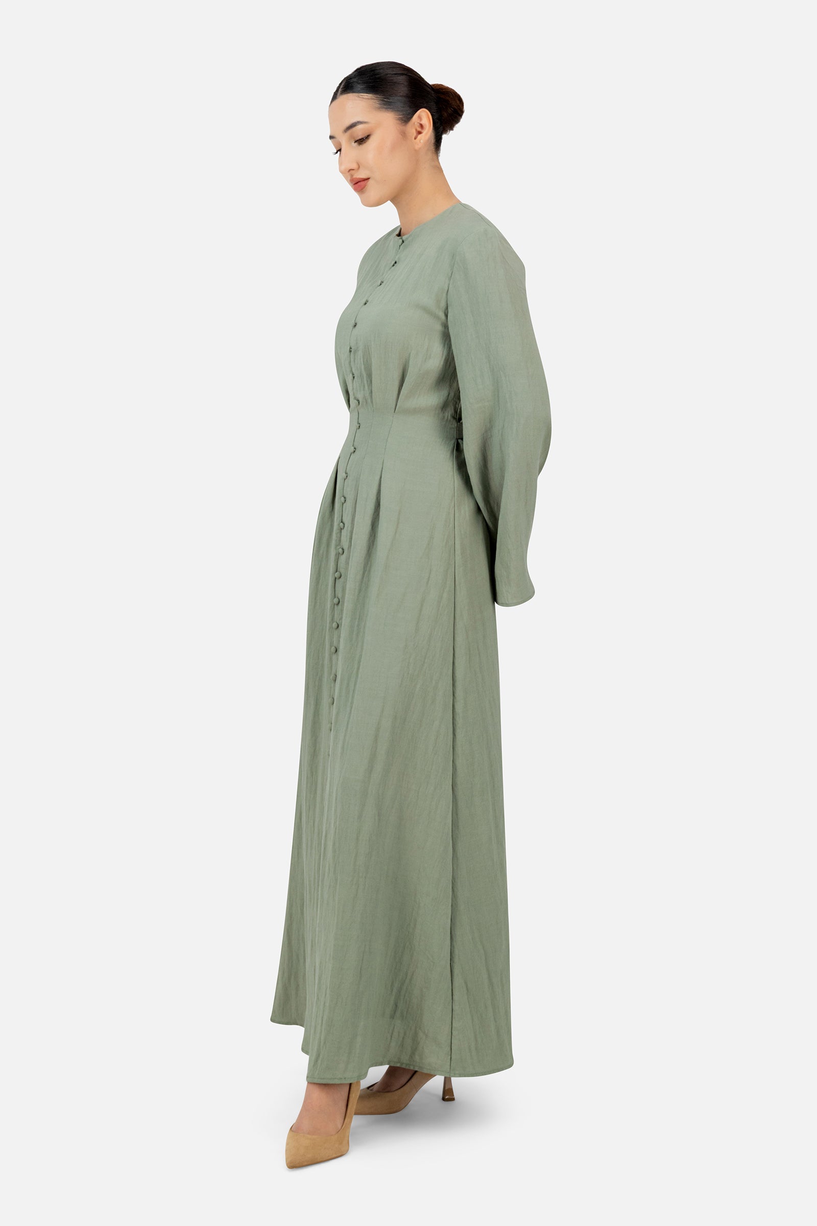 Side profile of the FARES Tailored Waist Button Front Dress in Clover highlighting the graceful drape of this refined maxi dresses for women style.