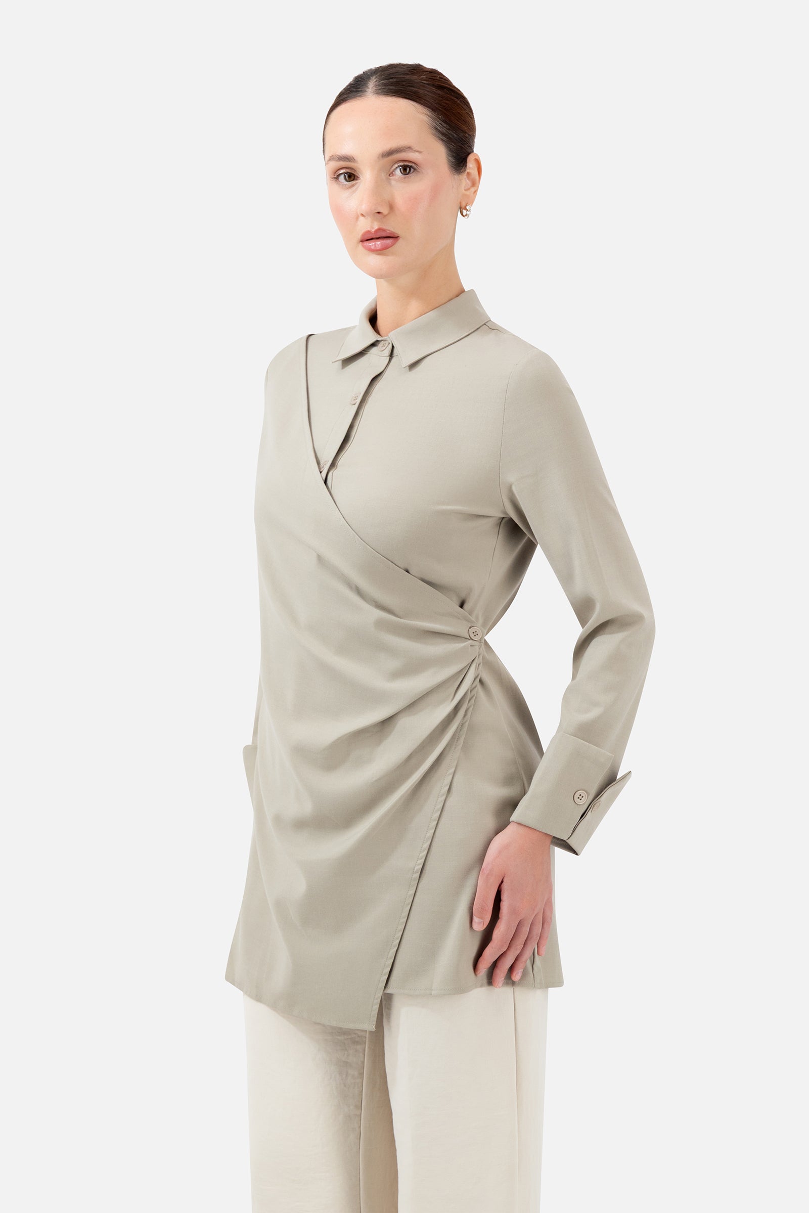 Woman standing in the Antique Green Wrap Detail Button-Up Shirt paired with relaxed trousers.