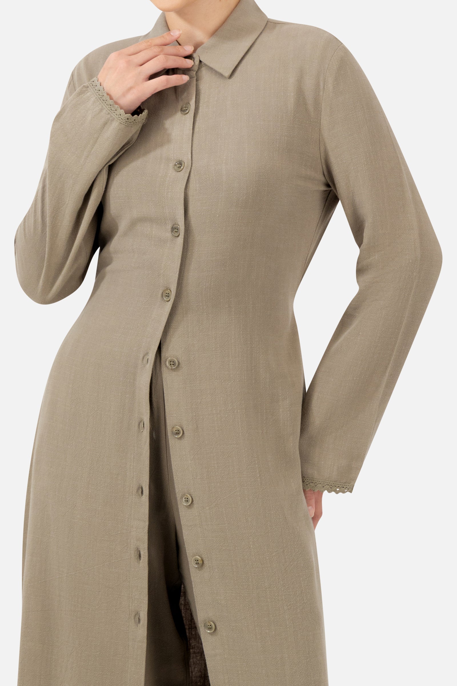 Close-up of the lace trim and button-front detail on the Haze long-sleeve tunic.