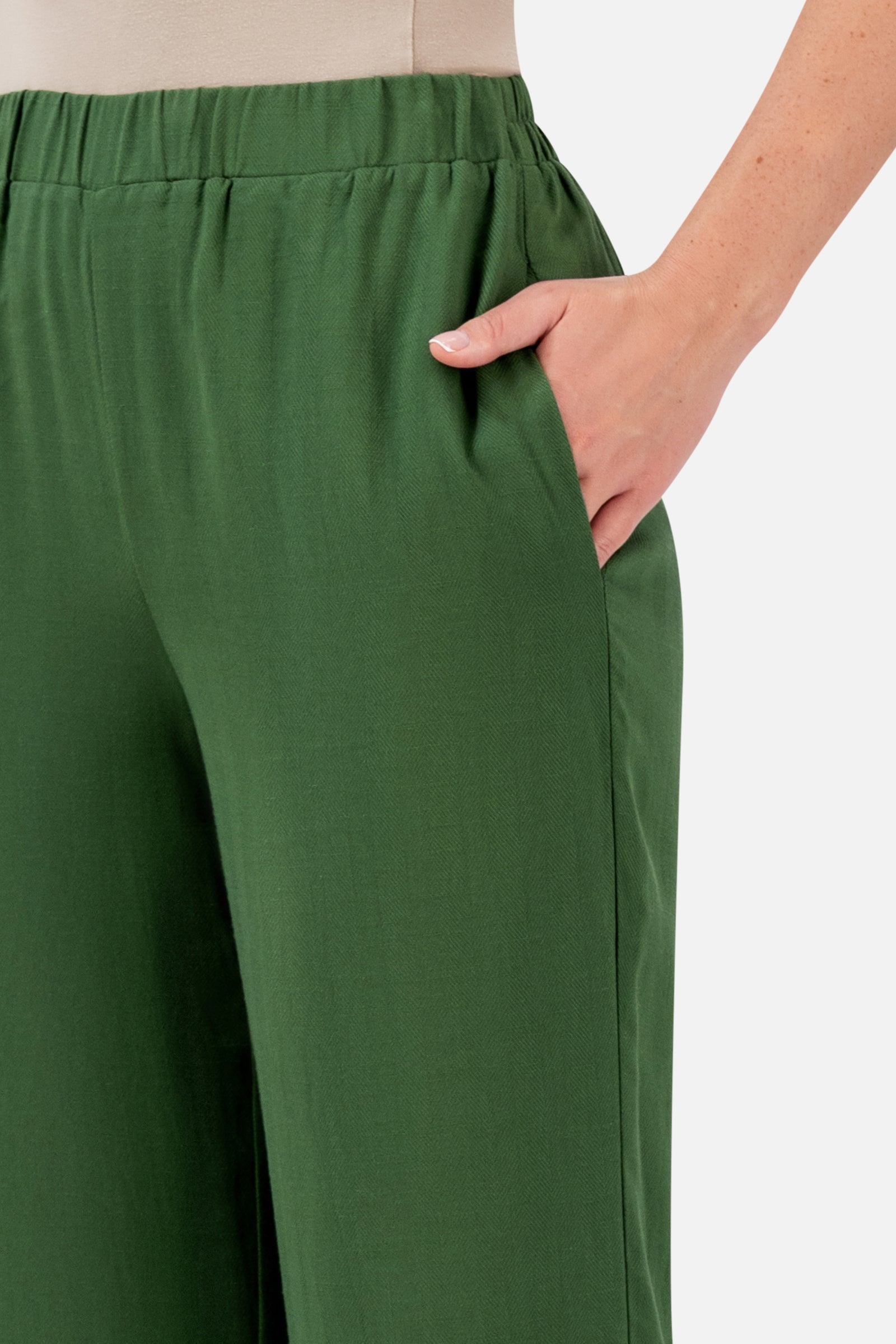 Closer view of the FARES Relaxed Fit Pants in Evergreen, highlighting the elasticated waistband, side pocket and softly textured fabric.