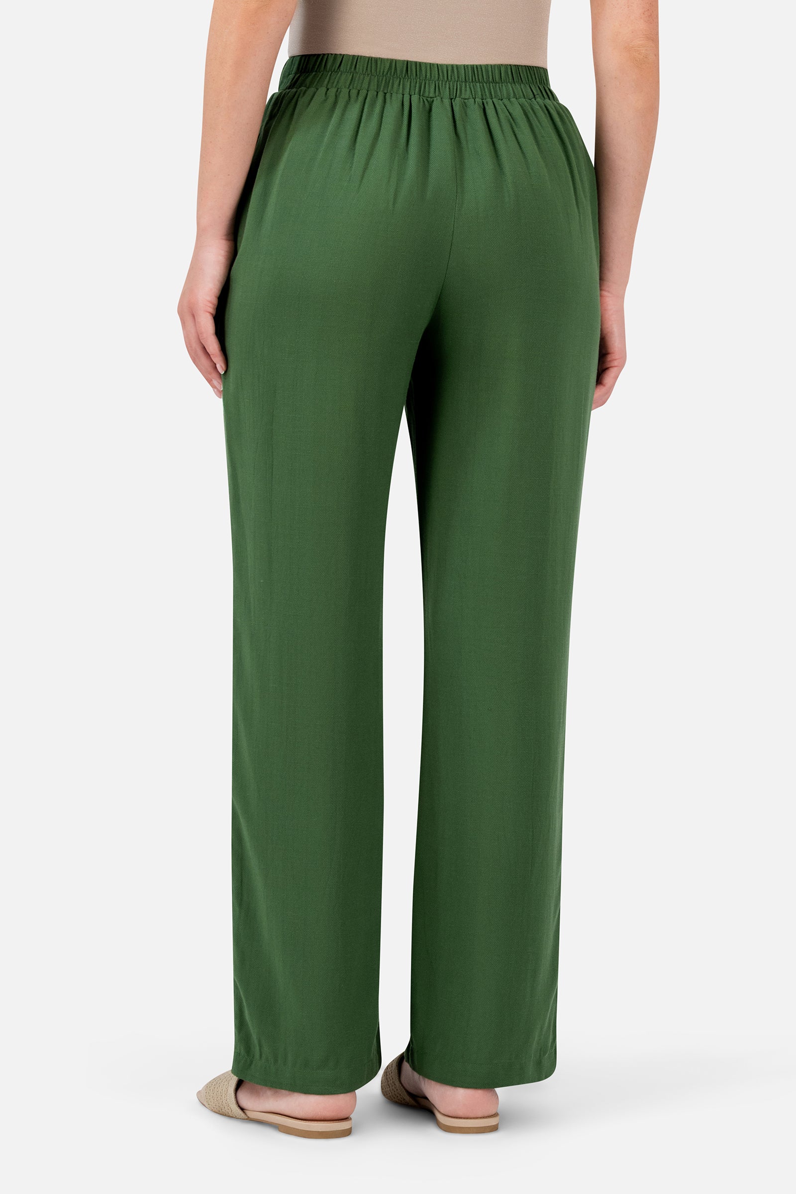 FARES Relaxed Fit Pants in Evergreen shown from the back, highlighting the relaxed silhouette and softly gathered elasticated waistband.