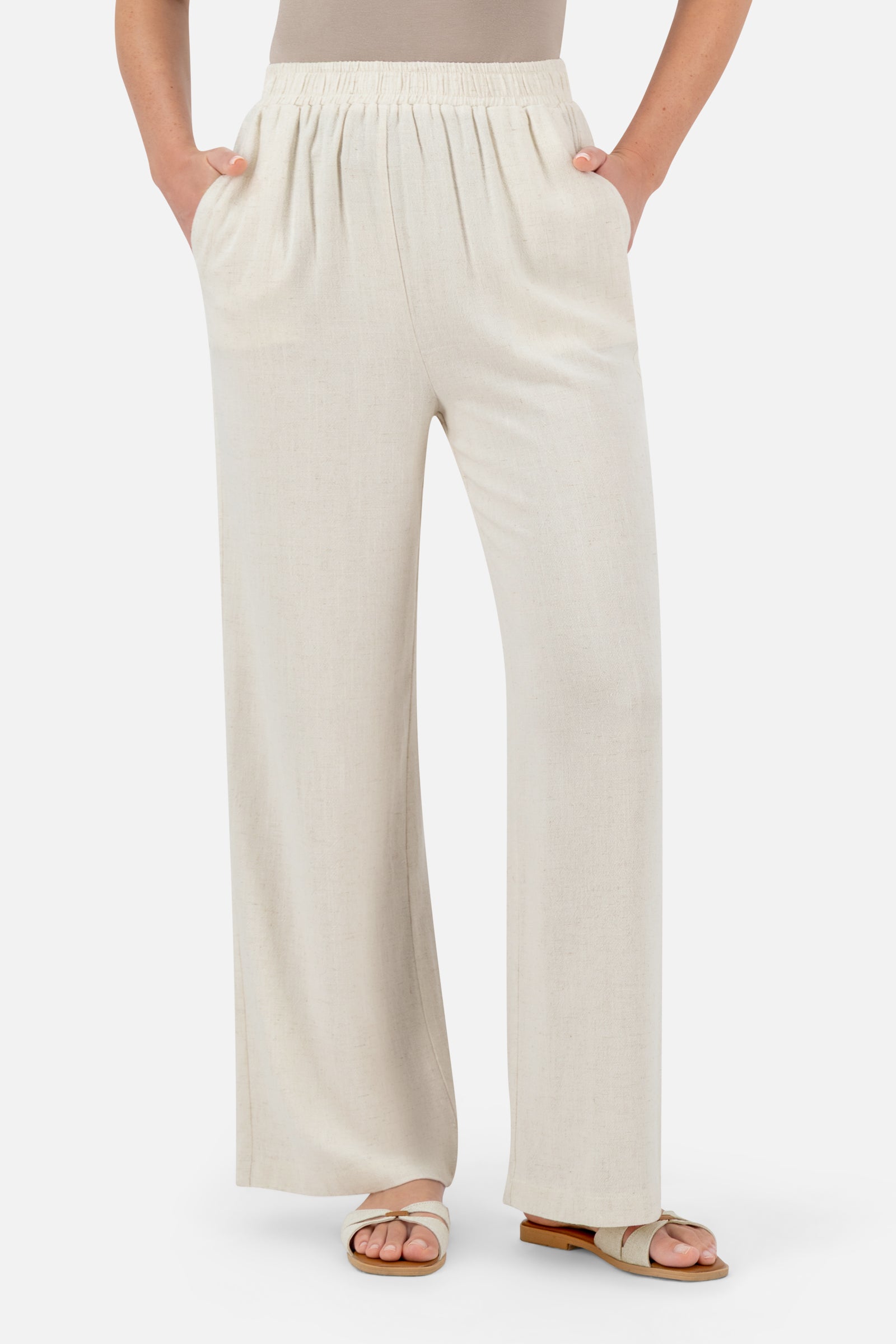 Woman standing in the Vanilla linen blend pants paired with the matching oversized linen top.
