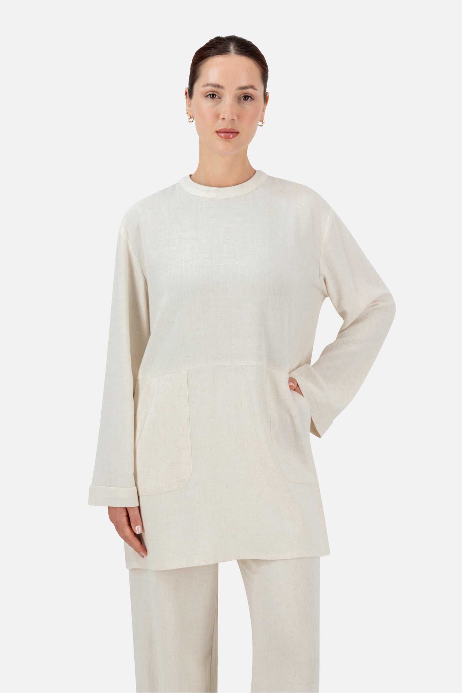 Woman standing in the Vanilla oversized linen top paired with matching linen blend pants.