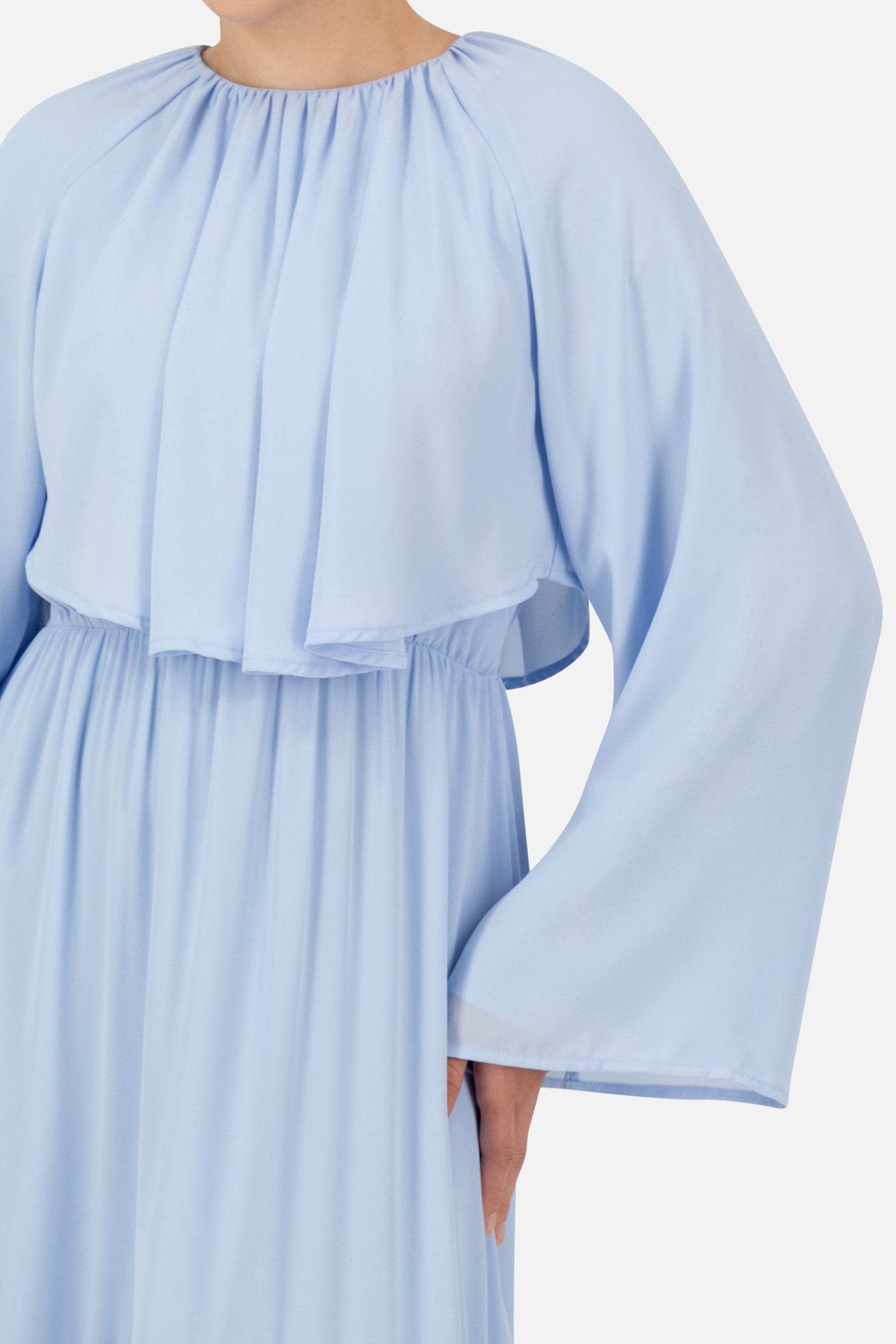 Detailed view of the powder blue FARES long sleeve maxi dress highlighting the layered bodice, wide sleeve and soft chiffon texture.