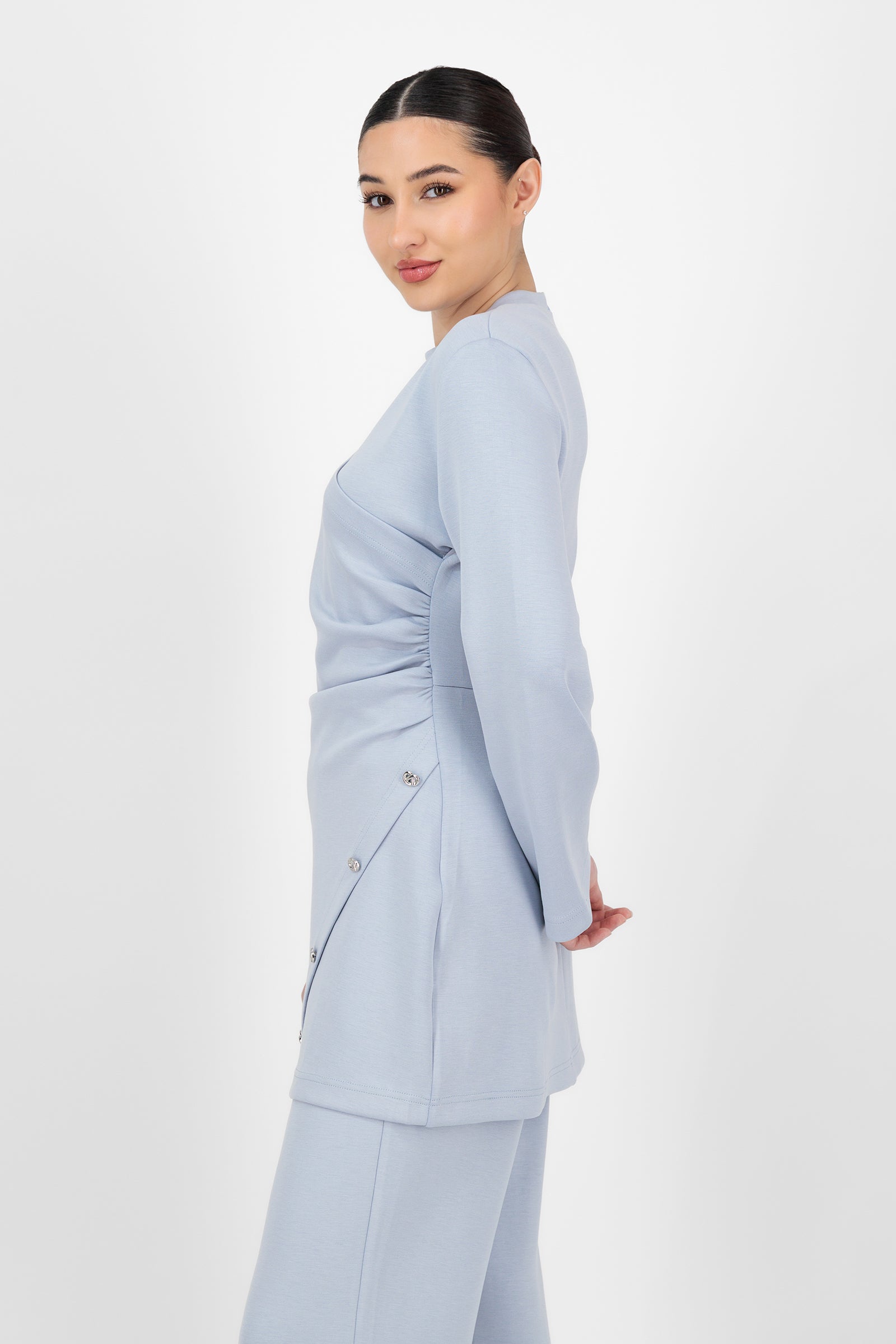 Side angle of the Buttery Side Ruched Tunic in Bluebell highlighting the ruched detailing and smooth drape, showing how this versatile piece elevates tunic clothing with a clean, modern shape.