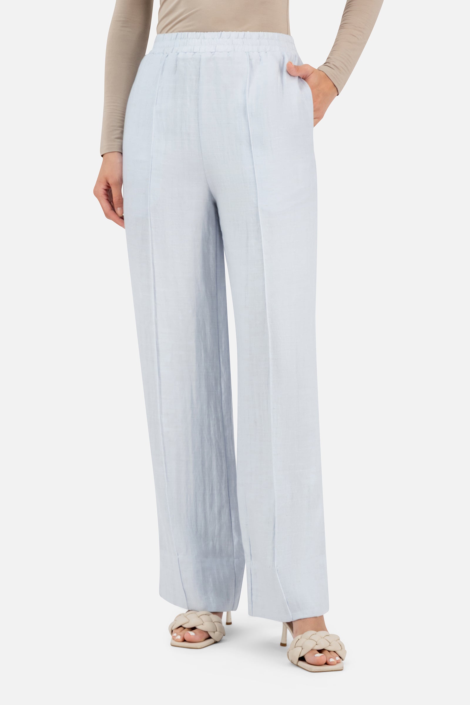 Model standing in the FARES Straight Leg Flowy Pants in Blueberry Cream featuring elegant straight leg pants with a soft flowing silhouette.
