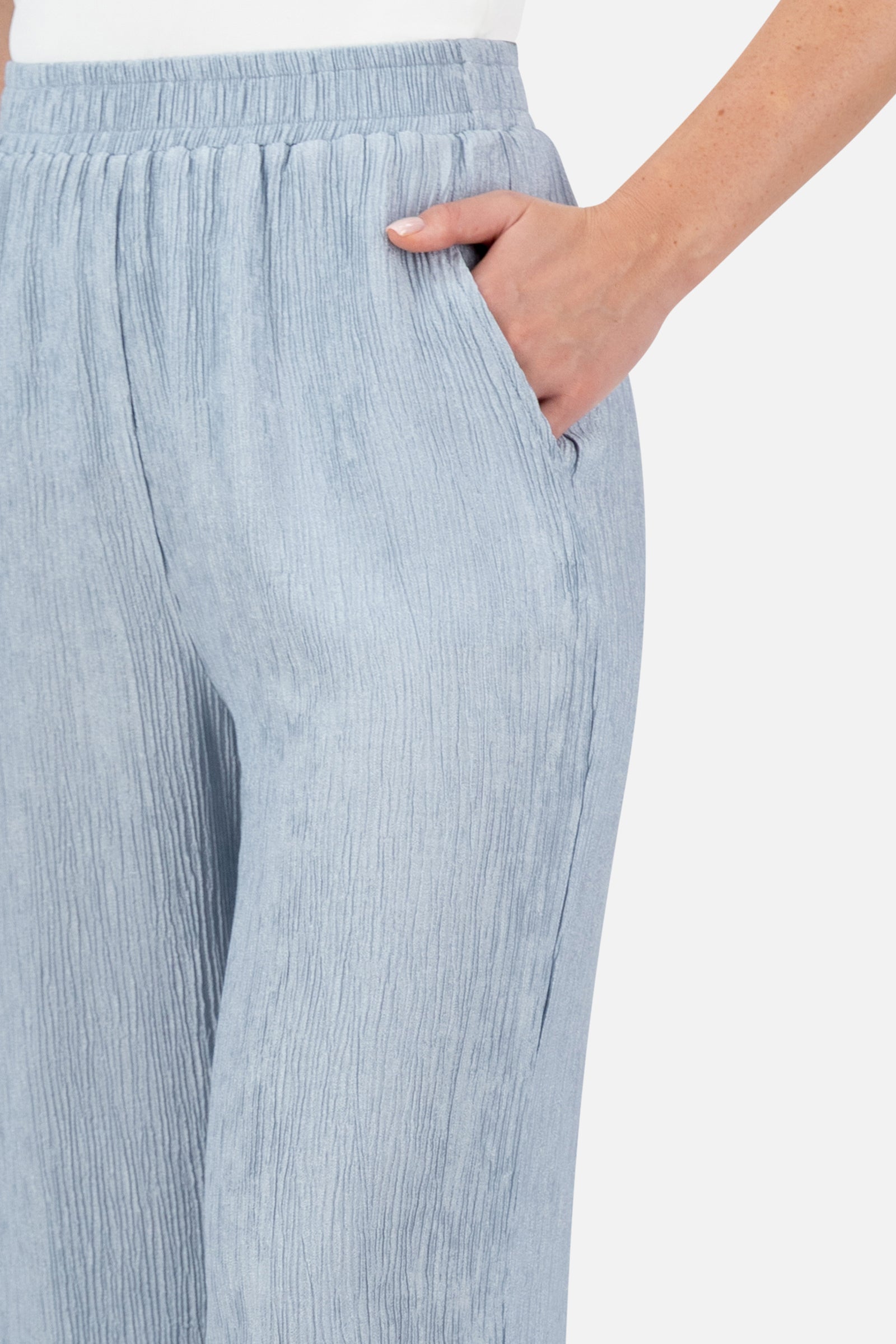 Close-up of the elastic waistband and rippled fabric detail on the Icy Blue relaxed fit pants.