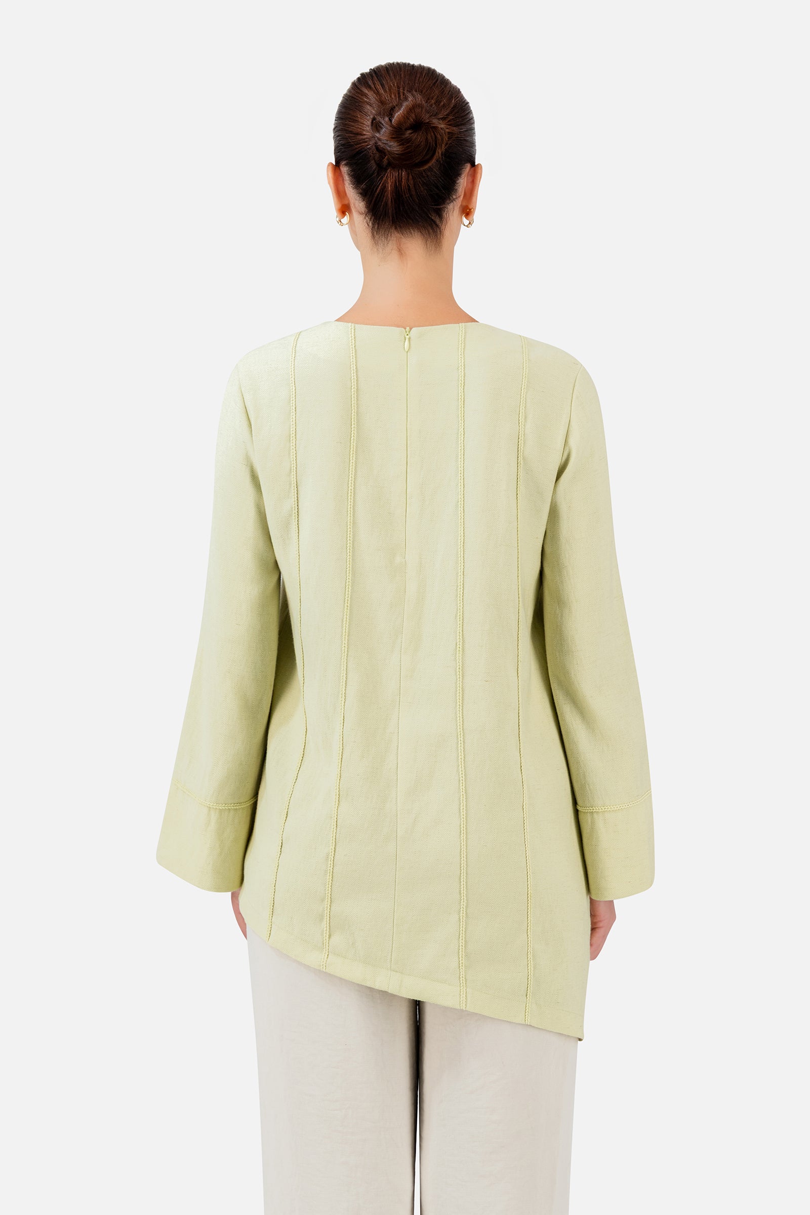 FARES Braid Detail Slanted Tunic in Honeydew shown from the back, highlighting the flowing shape and distinctive slanted hem.