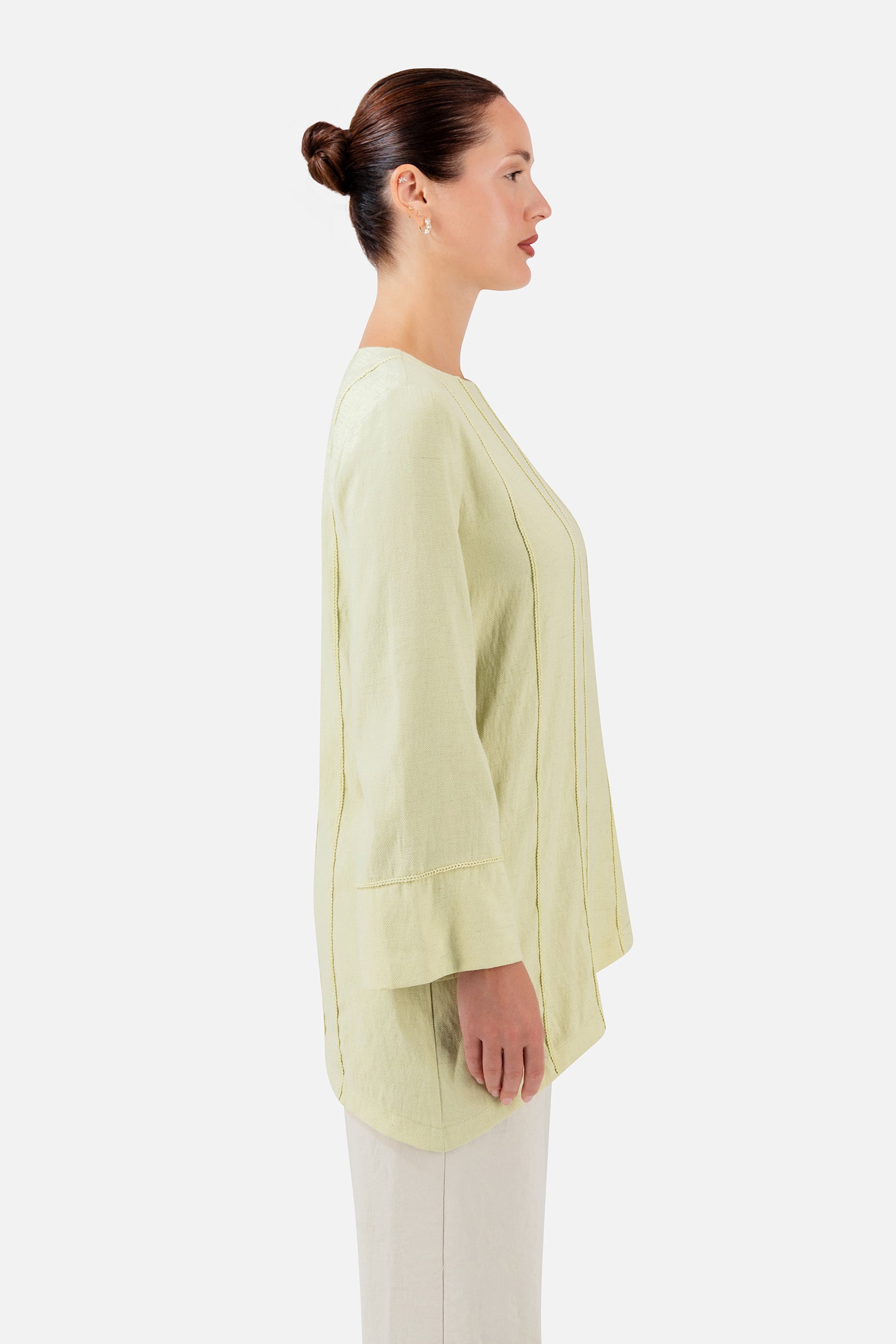 FARES Braid Detail Slanted Tunic in Honeydew shown from the side, featuring the asymmetric silhouette and relaxed fit of this tunic.