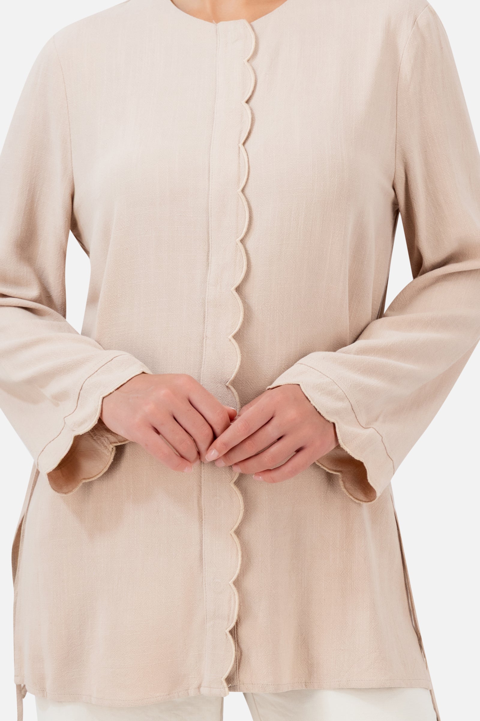 Closer view of the FARES Scalloped Detail Linen Blend Top in Shell, showing the delicate scalloped edging, linen blend texture and side ties.