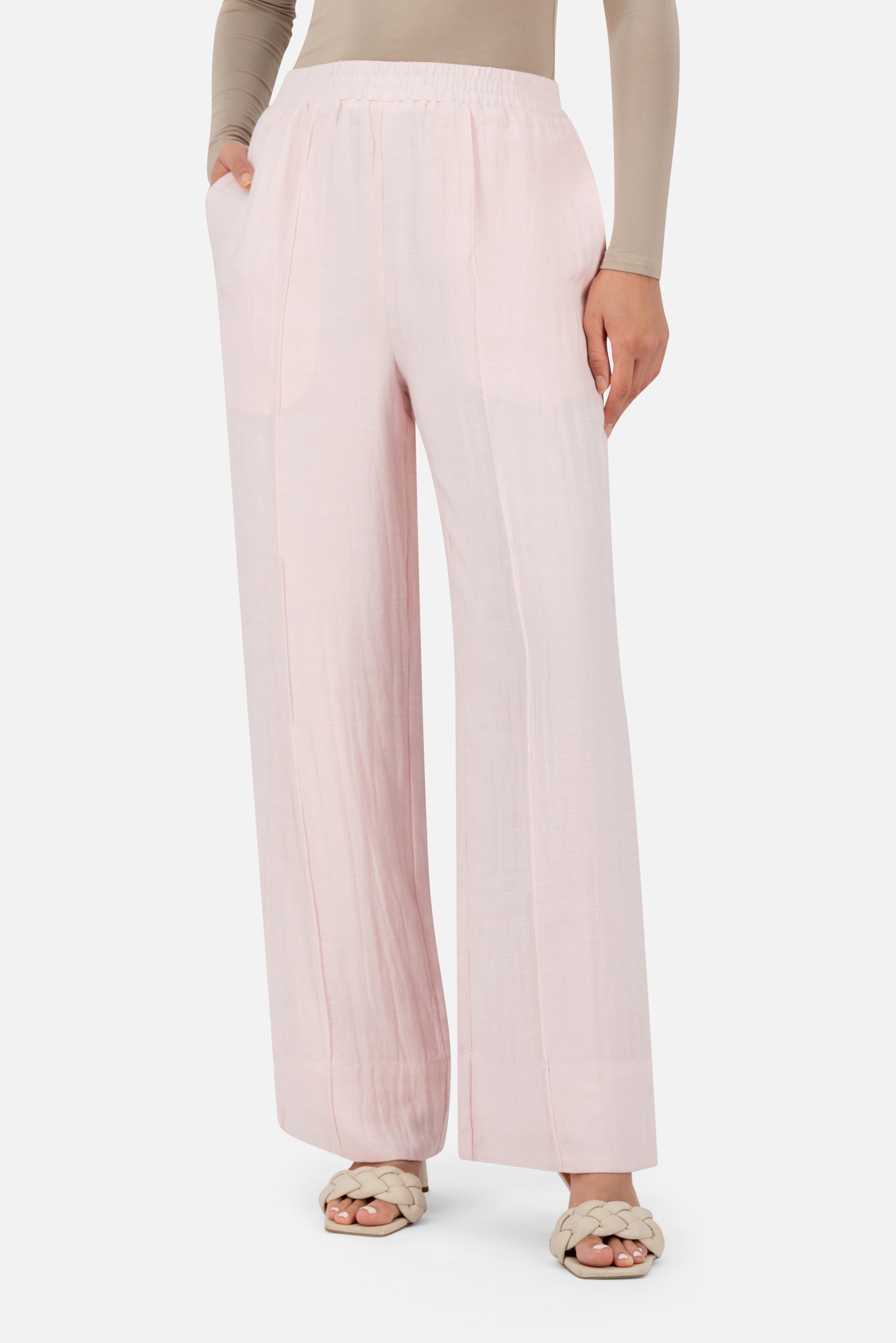 Girl posing in the Strawberry Cream FARES straight leg pants with a flowing shape and comfortable elastic waistband.
