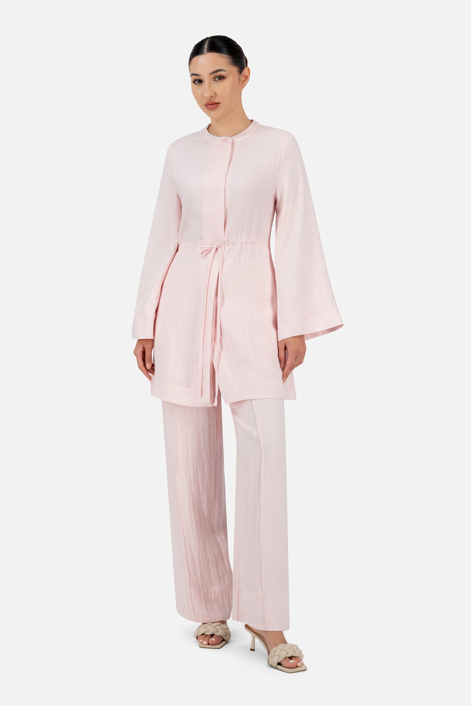 Woman styled in the Strawberry Cream FARES tunic clothing set showcasing the flowing silhouette and elegant wide sleeve design.