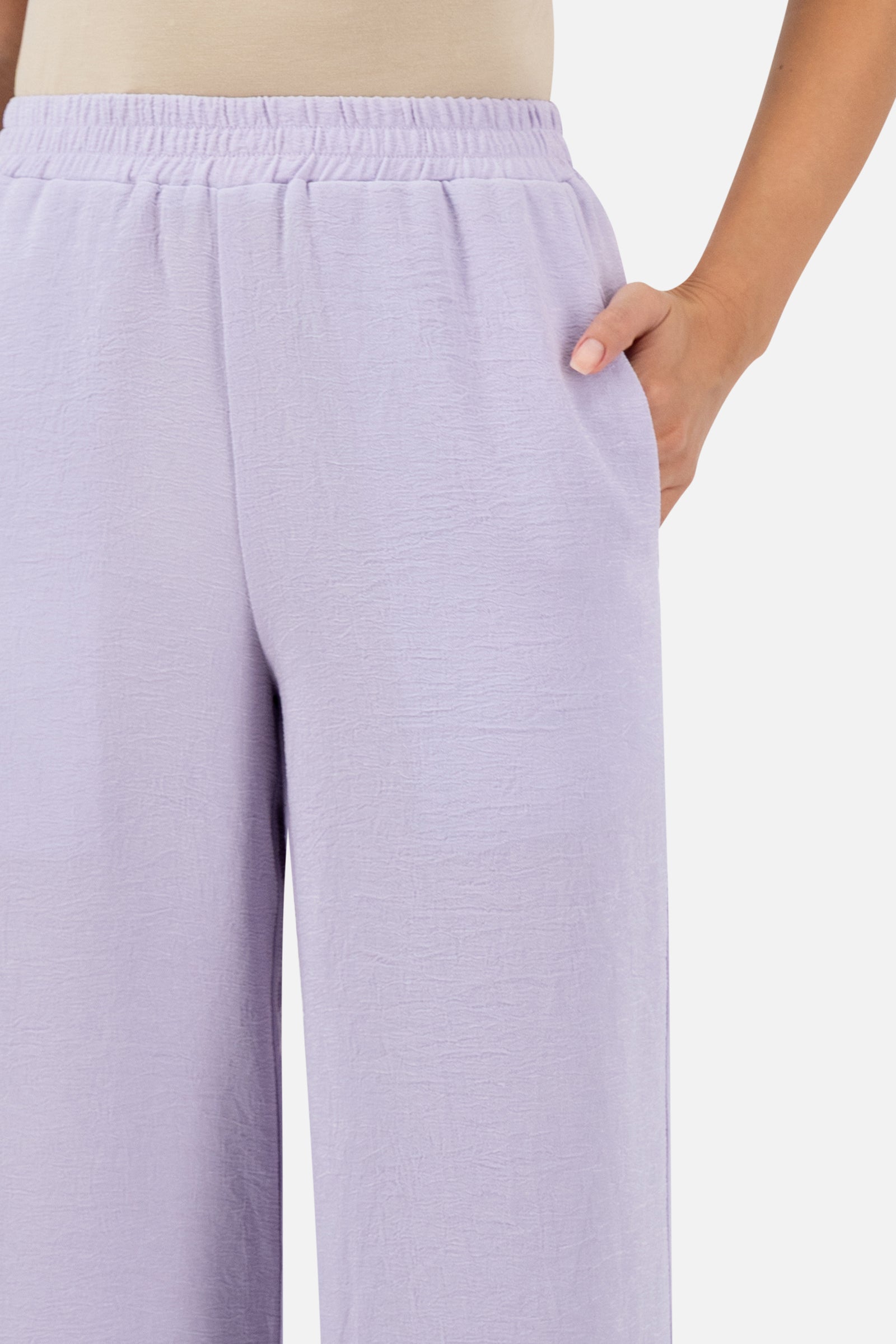 Close-up of the elastic waistband and side pocket detail on the Lilac relaxed fit pants.
