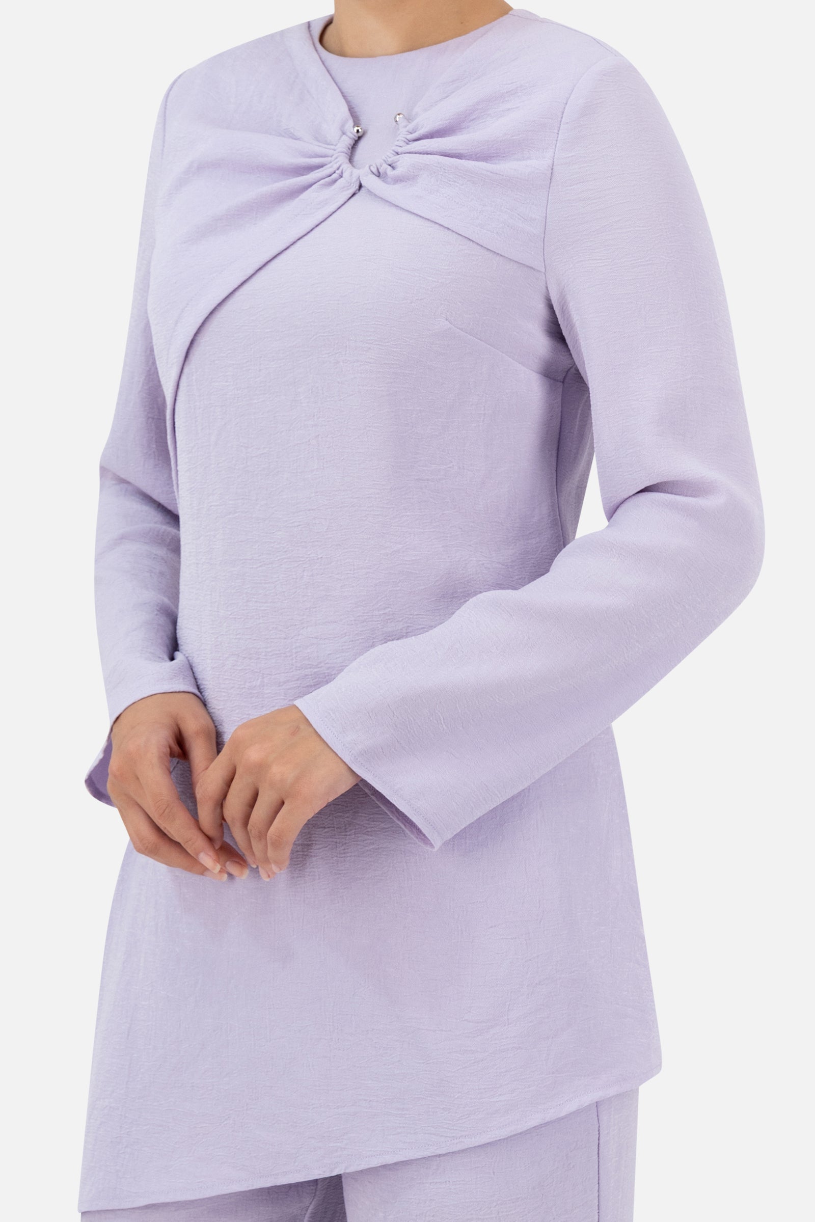Close-up of the gathered ring detail and asymmetric neckline on the Lilac tunic.