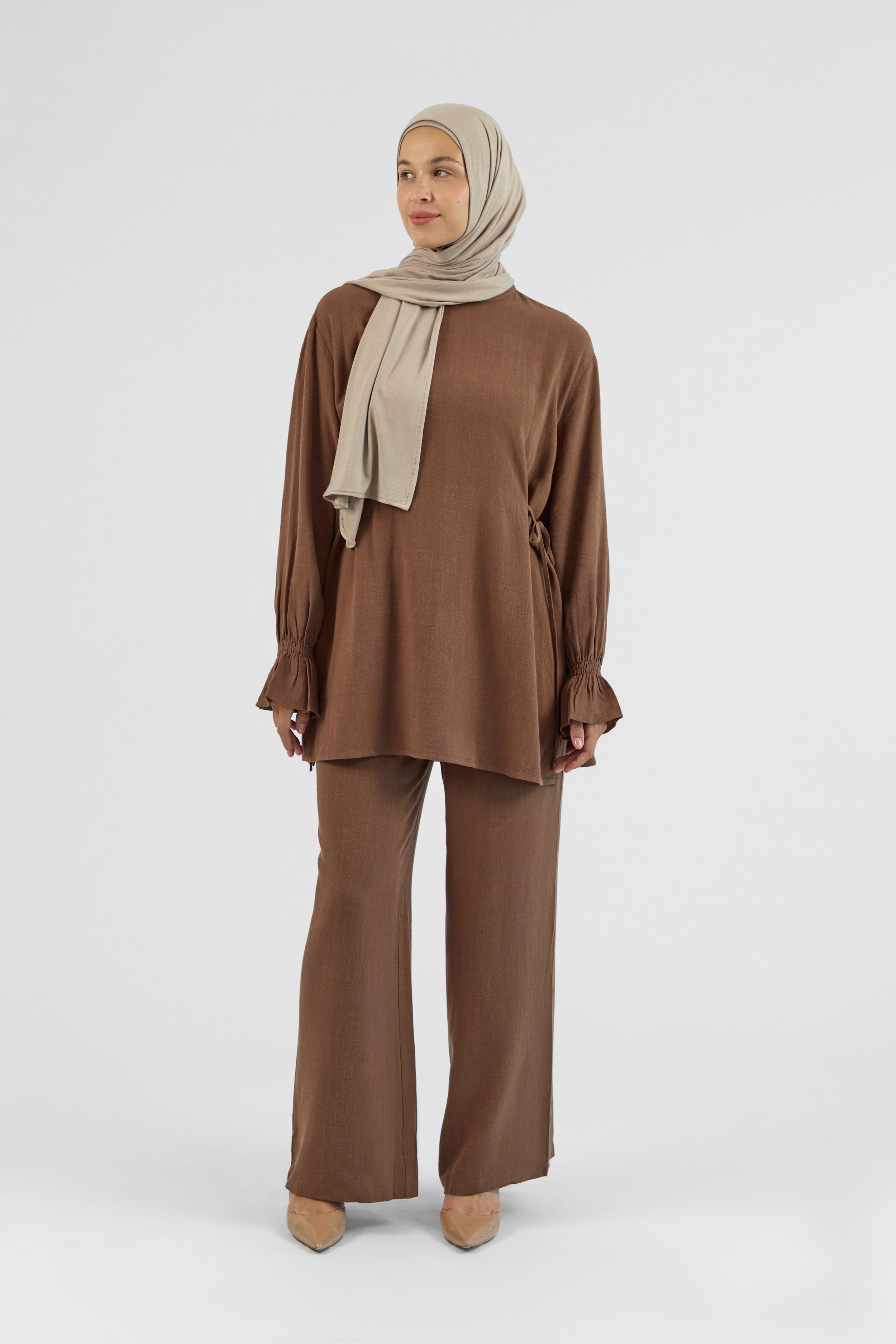Colour: Chocolate. A model is in a front pose in a Bow Detail Linen Blend Top.