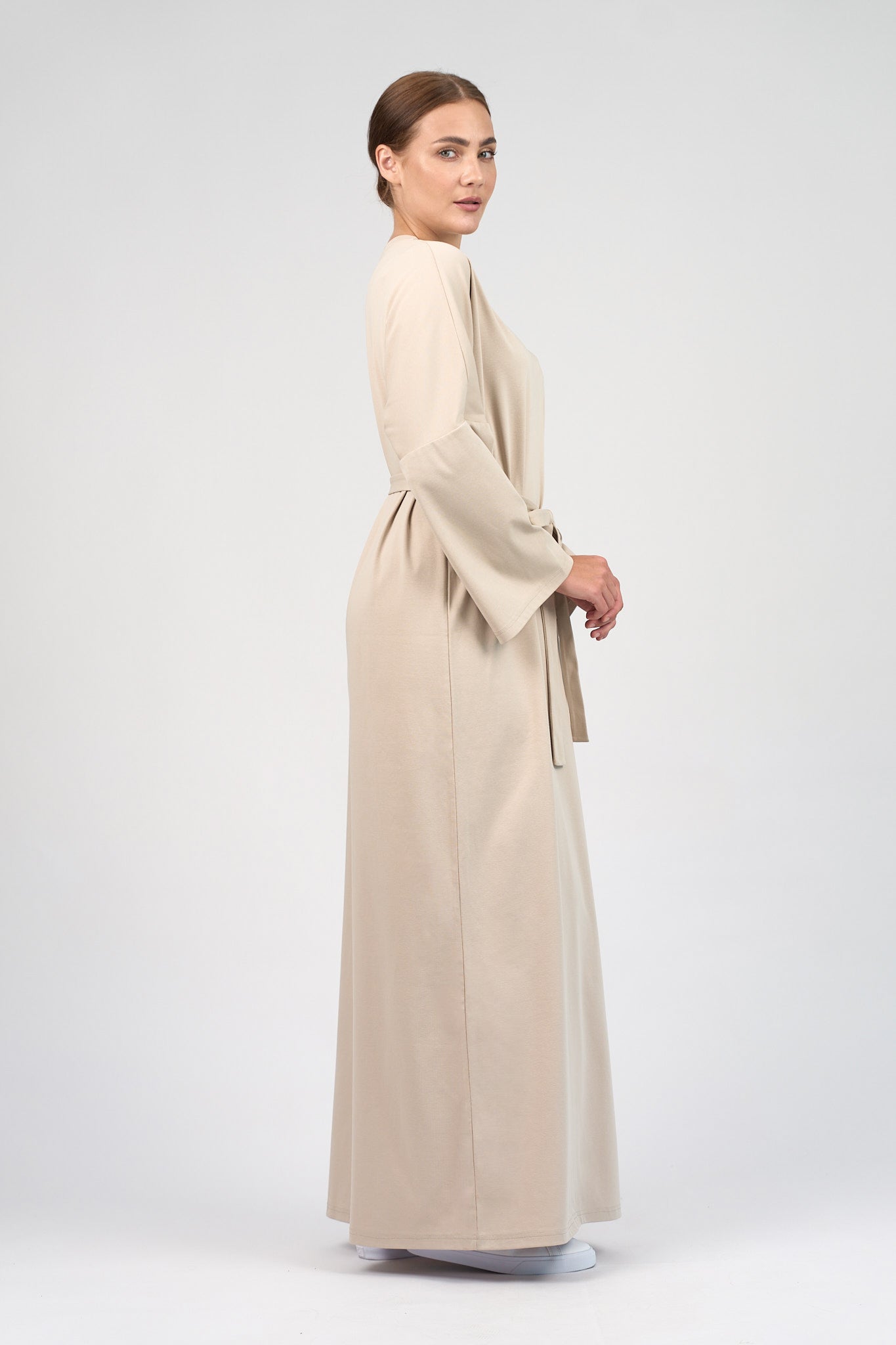 Colour: Mink. A model is turned to the right in a Cotton Maxi Dress