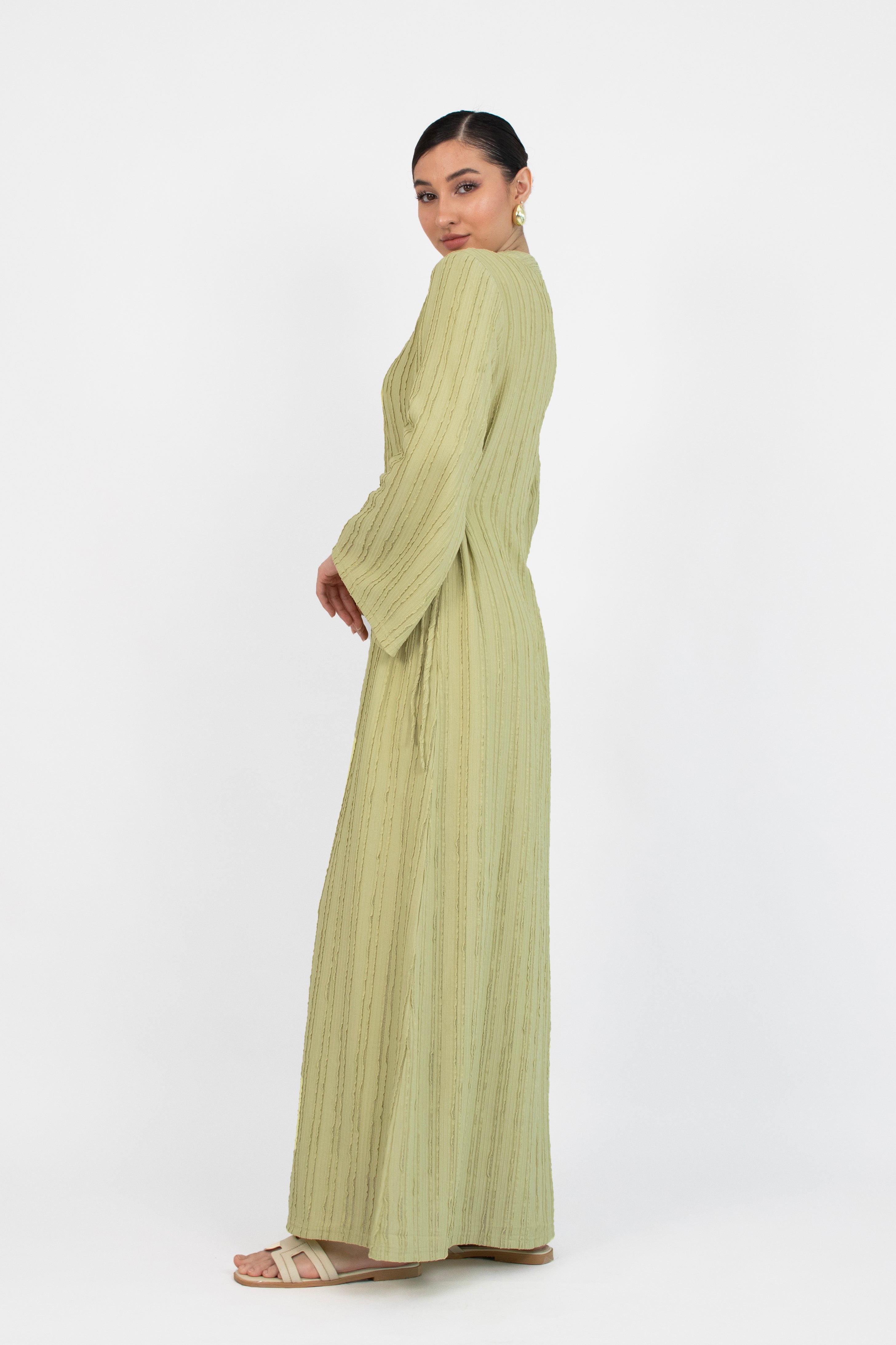 Colour description: Lime The girl is turned left in a textured bow detail dress.