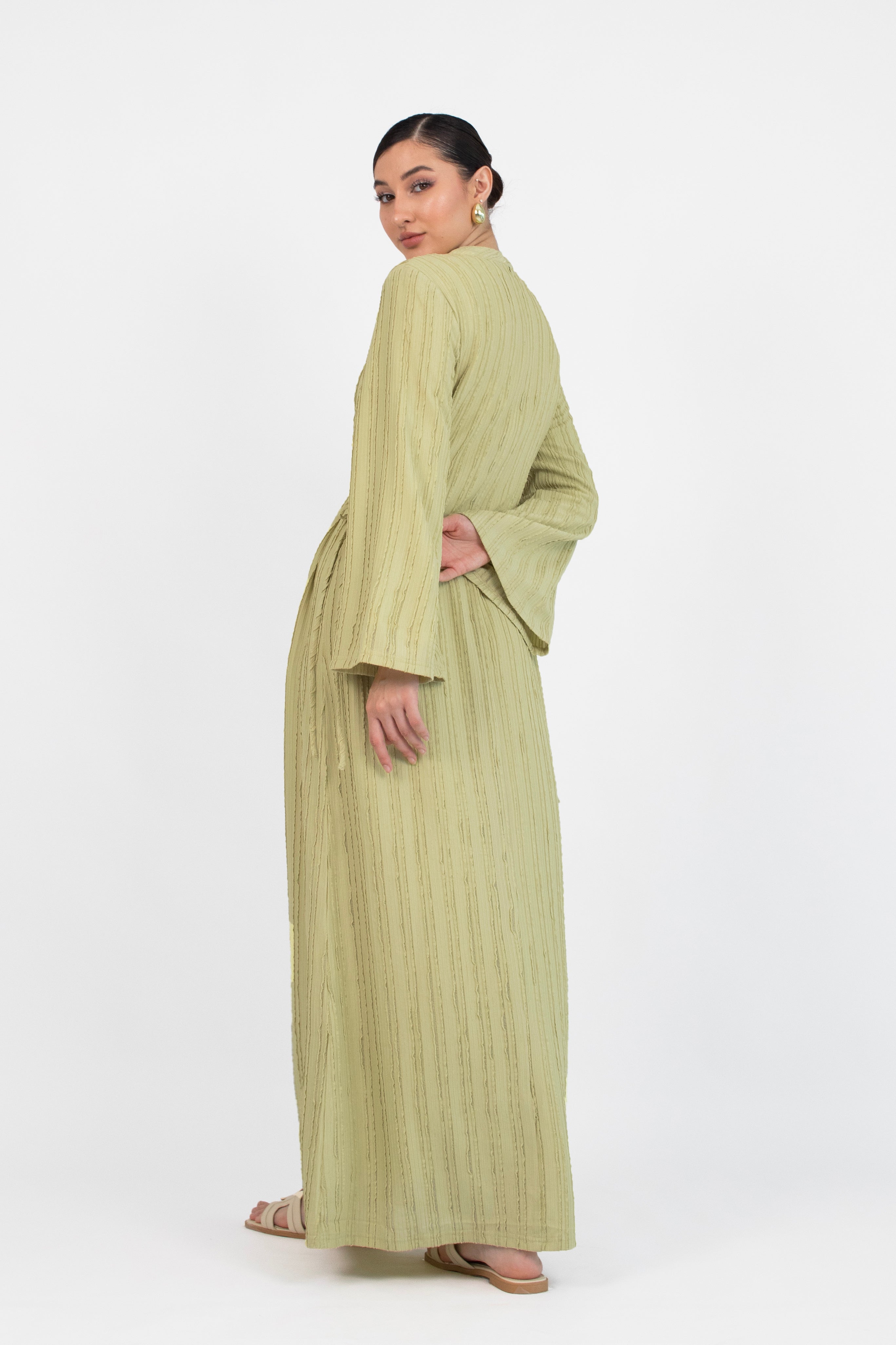 Colour description: Lime The model is shown from behind in a bow dress.