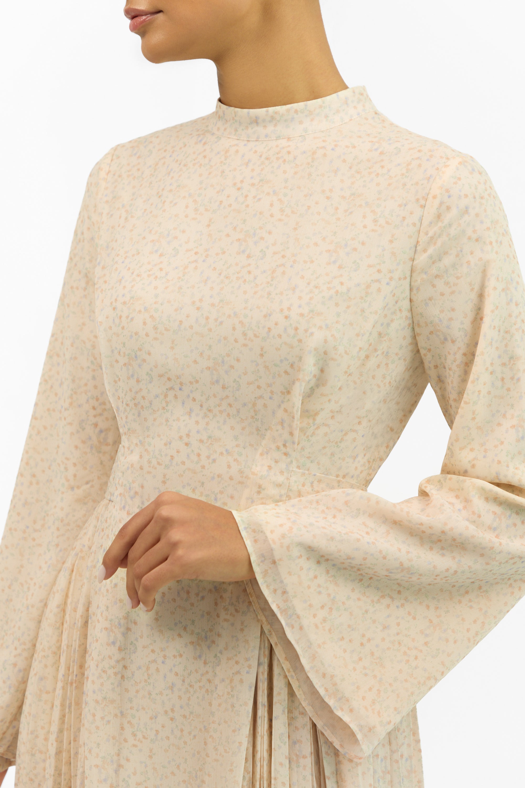 Detail of the pleated fabric and printed floral design on the FARES Printed Tie Dress with Pleats.