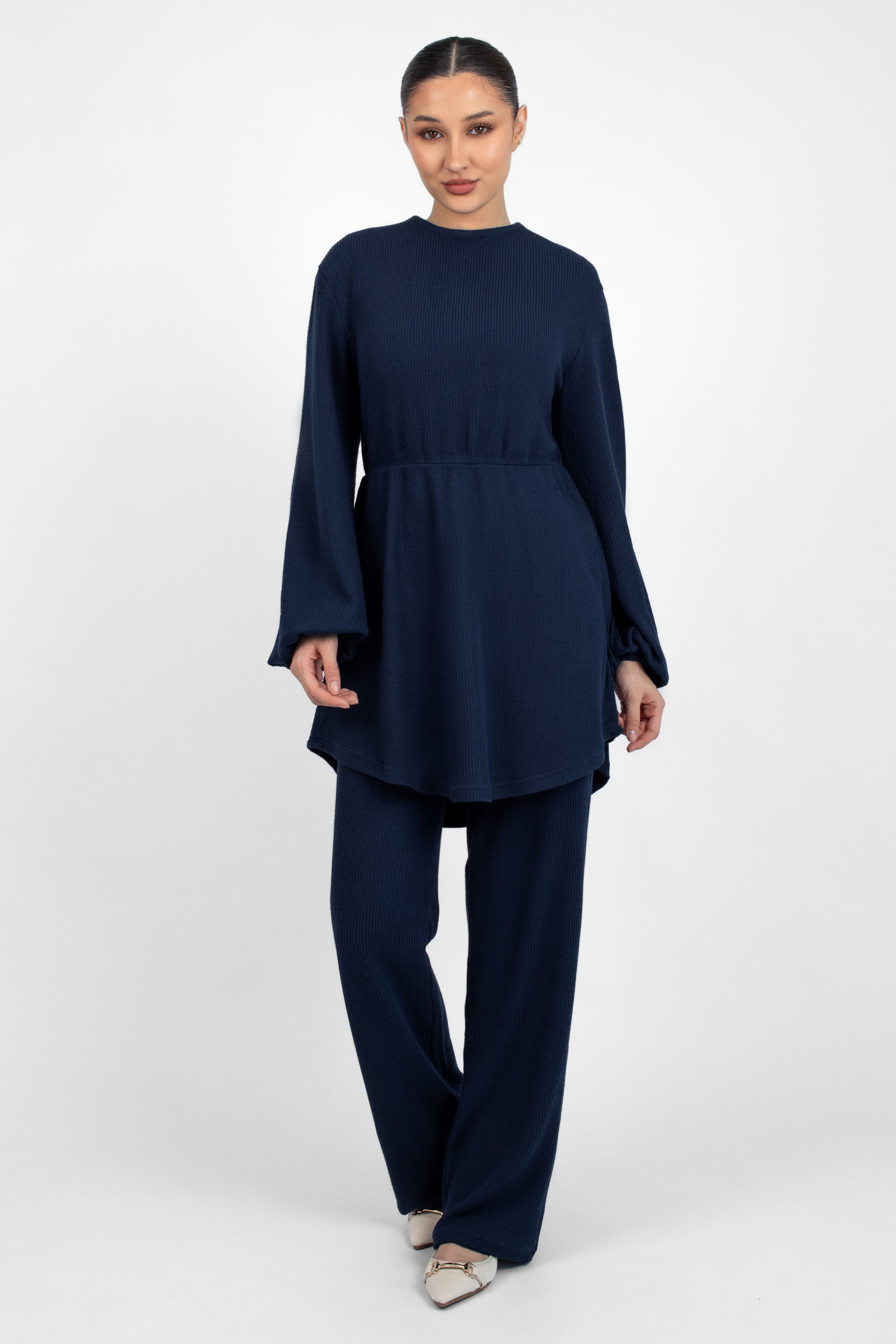 A front pose from a woman in a Knit Peplum Top.	Colour: Navy