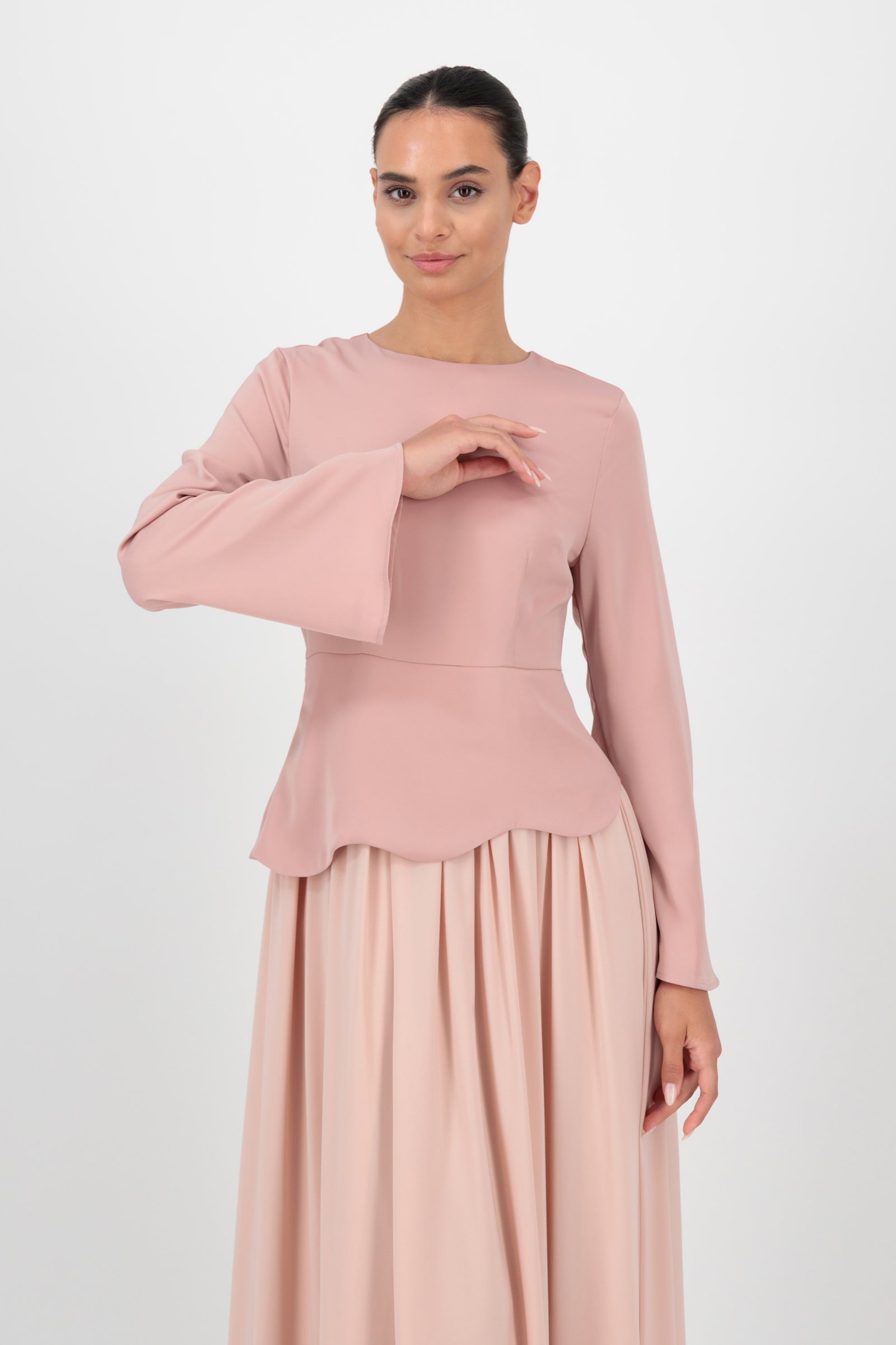 Model faces forward in the FARES Two Tone Scalloped Peplum Dress in Farawla, emphasizing the scalloped peplum detail and structured bodice.