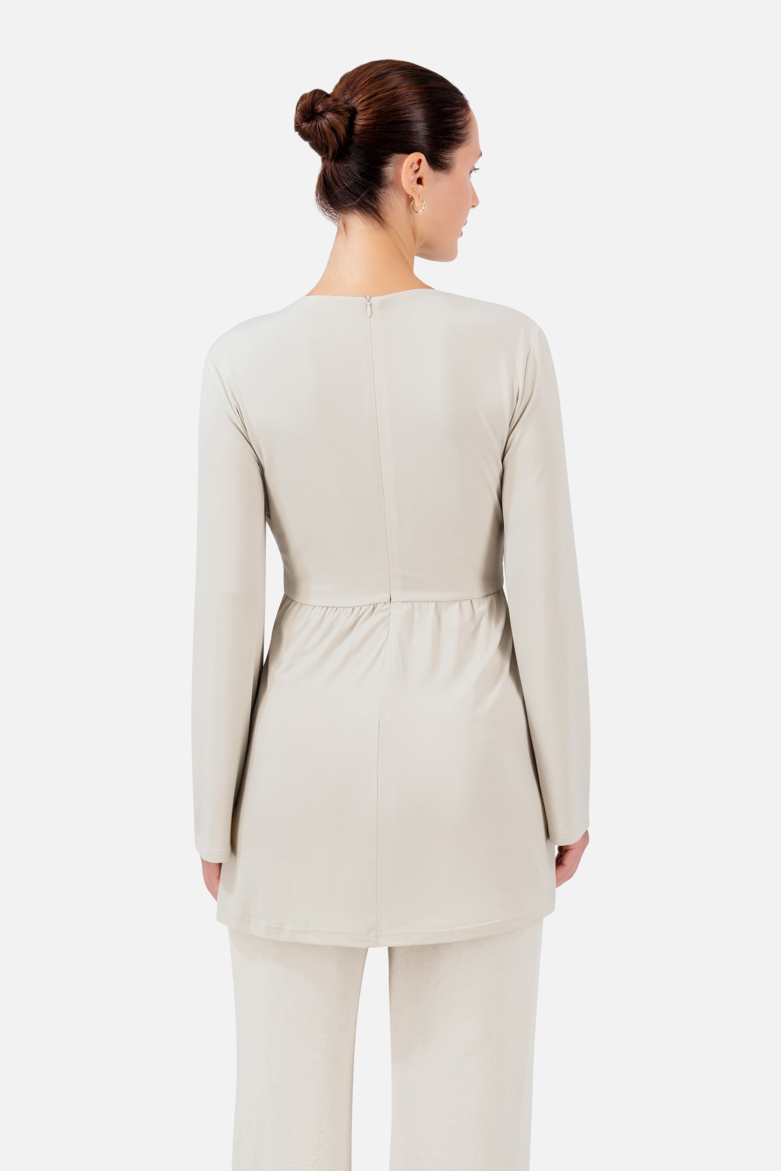 FARES Side Draped Tunic in Vanilla Cream shown from the back, highlighting the clean longline shape and softly fitted silhouette.