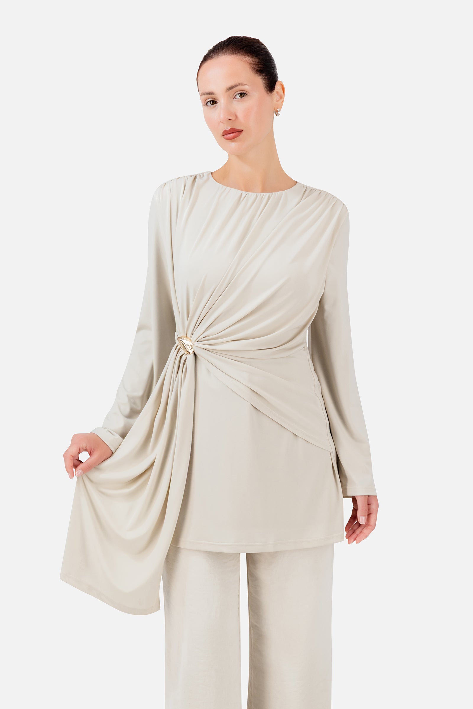 FARES Side Draped Tunic in Vanilla Cream shown at an angle, highlighting the gathered side detail and flowing draped fabric.