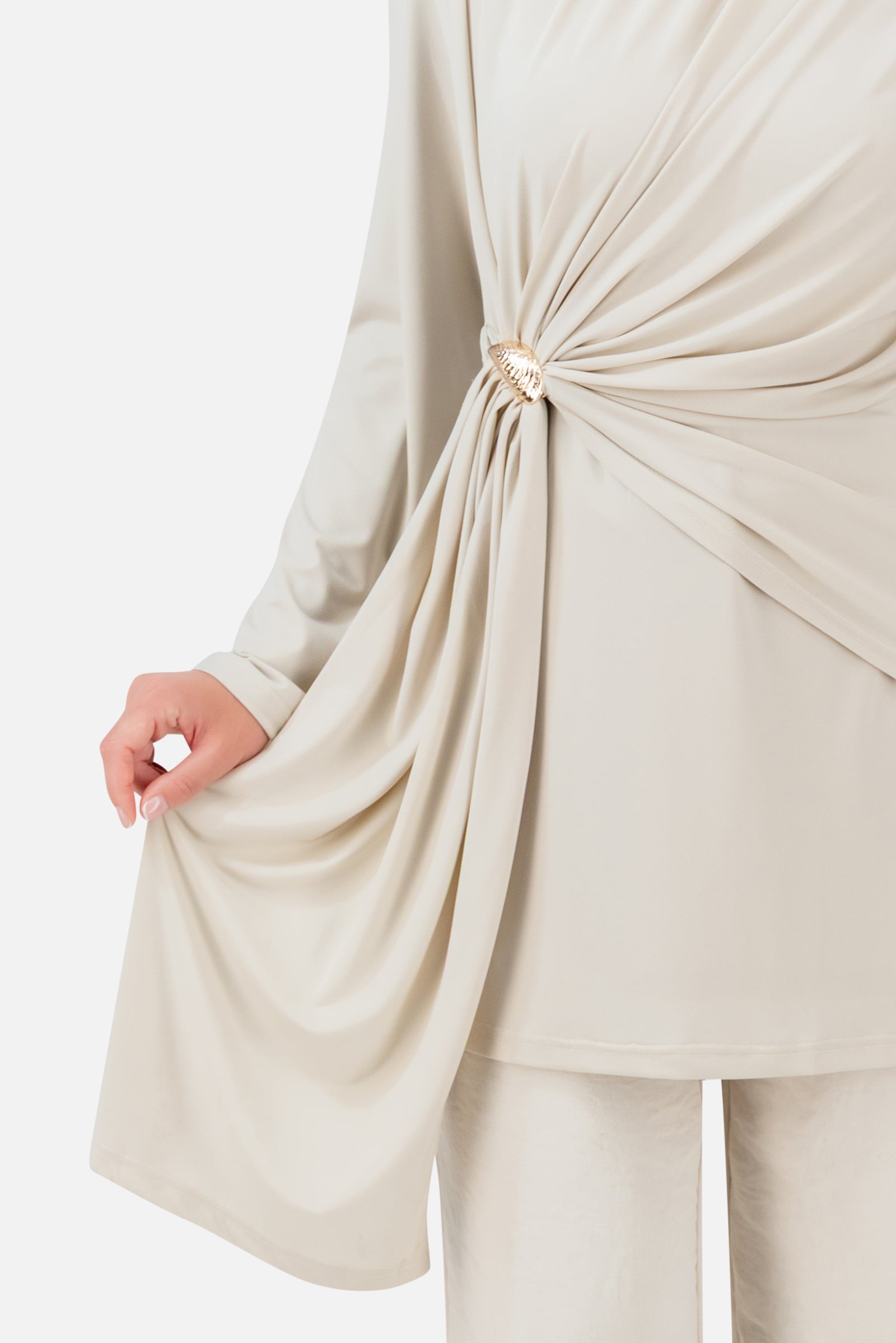 Closer view of the FARES Side Draped Tunic in Vanilla Cream, showing the soft gathering and cascading fabric along the side.