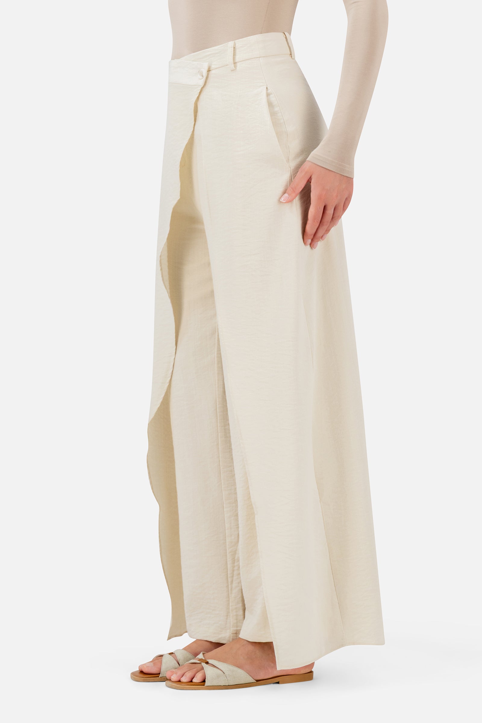 FARES Skirt Overlay Trousers in Oats shown from the side, featuring the layered skirt panel and fluid silhouette of these women's trousers.