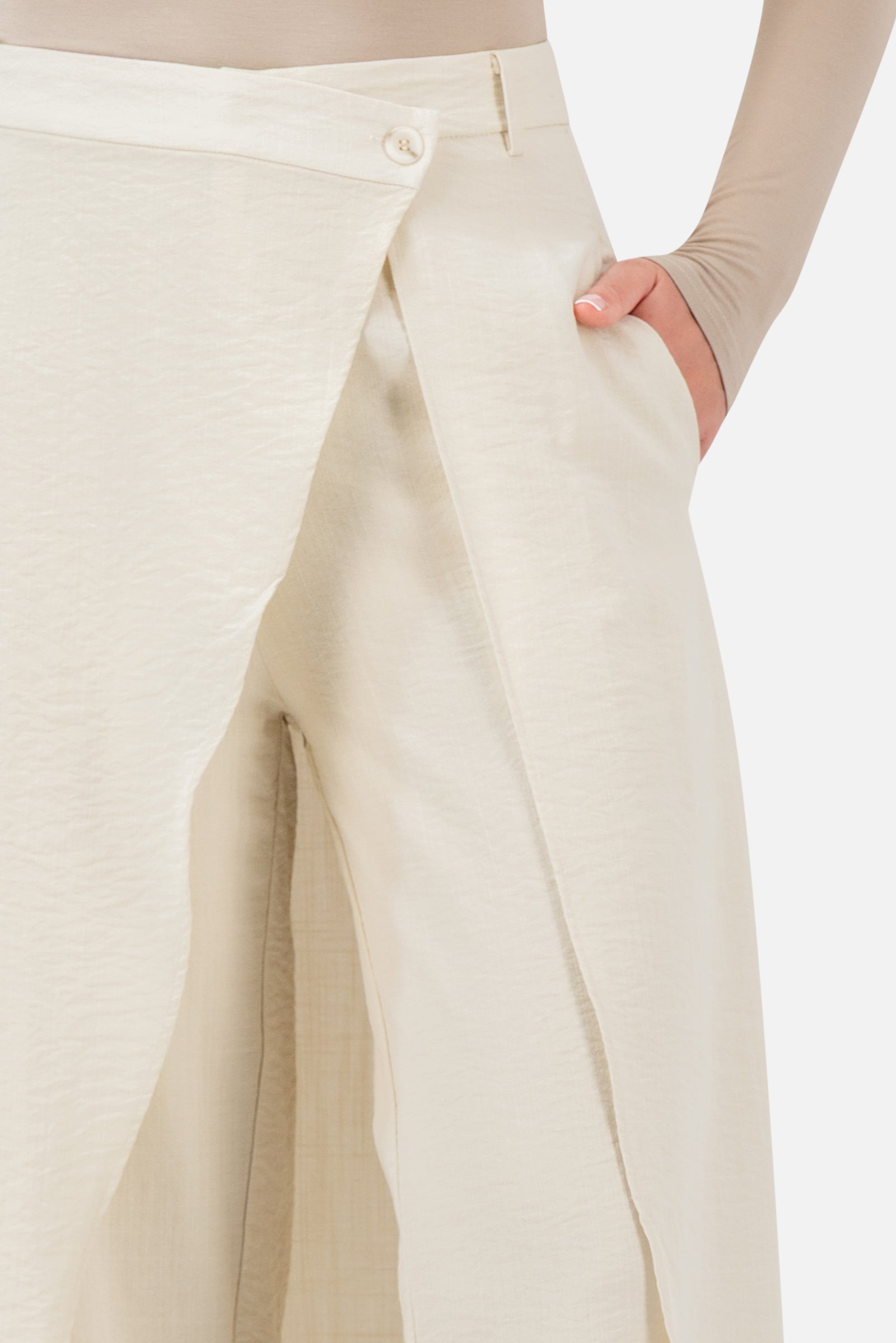 Closer view of the FARES Skirt Overlay Trousers in Oats, showing the overlapping skirt detail, waistband and practical side pocket.