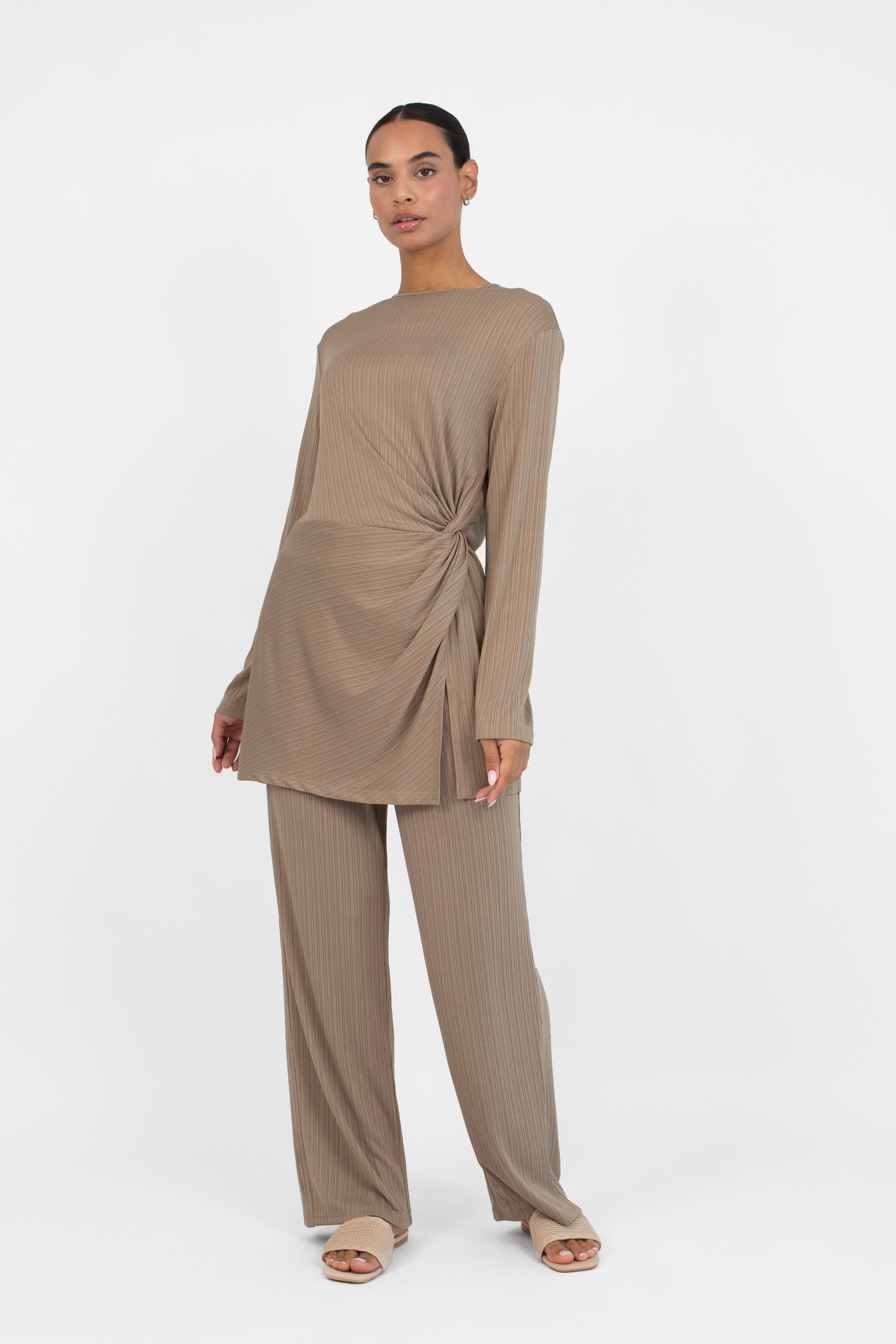 Colour: Taupe. A woman in a front pose in a Ribbed Side Twist Top.