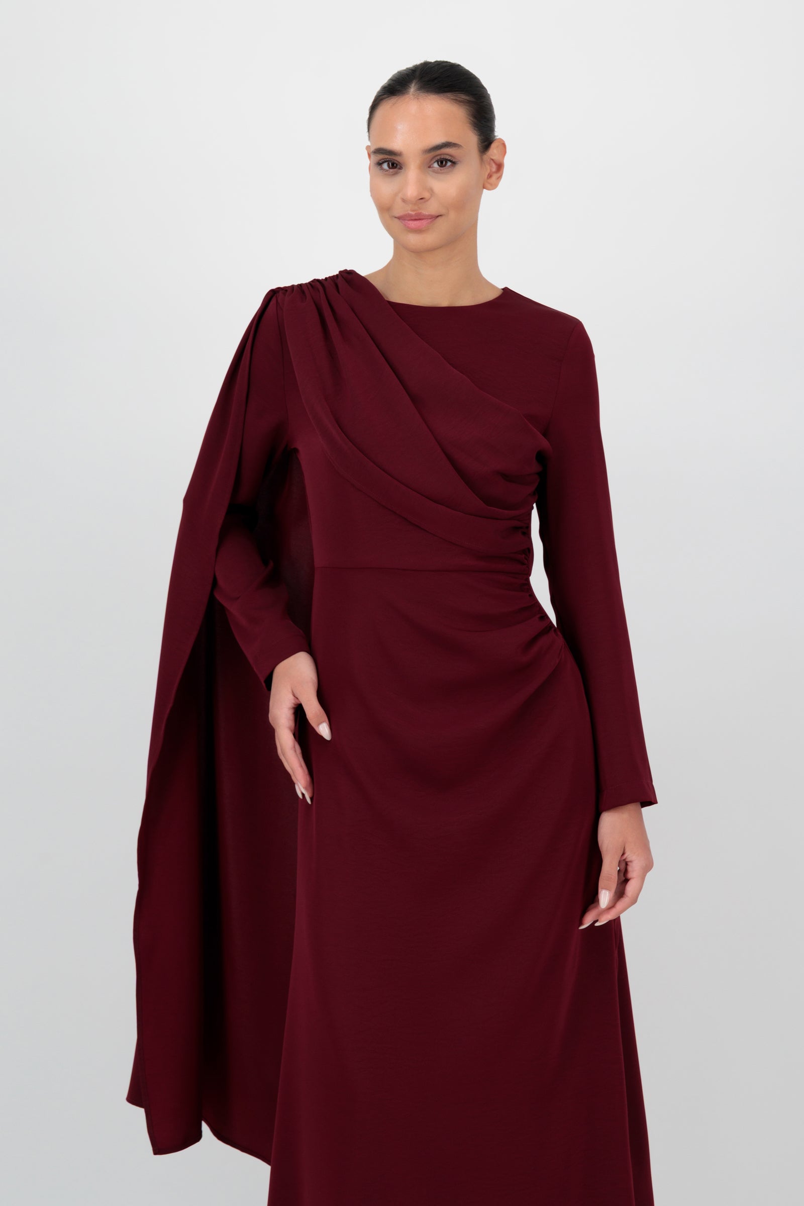 Front angled view of the FARES Ruched Shoulder Detail Dress in Karaz emphasizes the sculpted shoulder detail and gathered texture of this ruched dress.