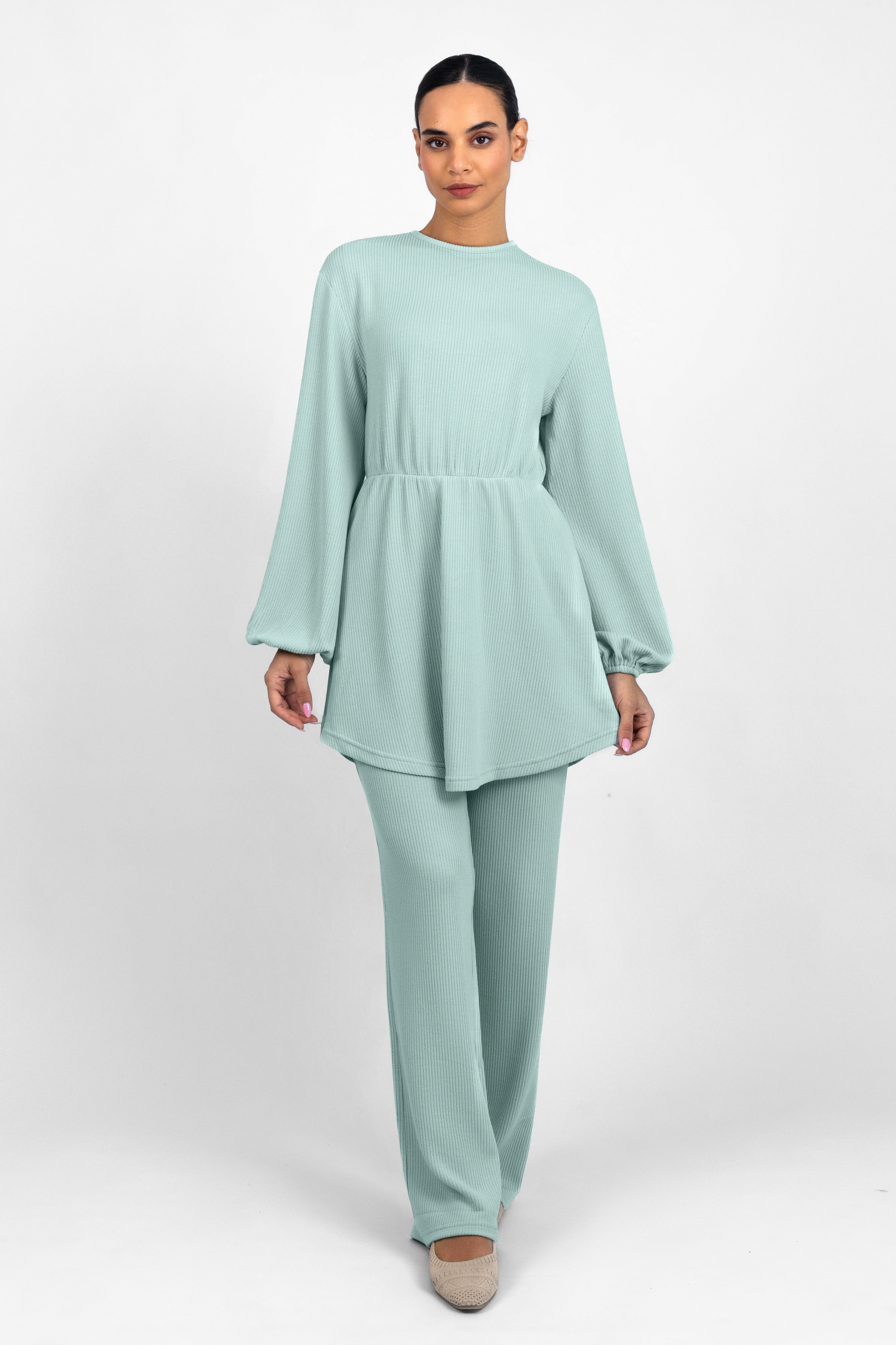 A front pose from a woman in a Knit Peplum Top.	Colour: Icy: Blue