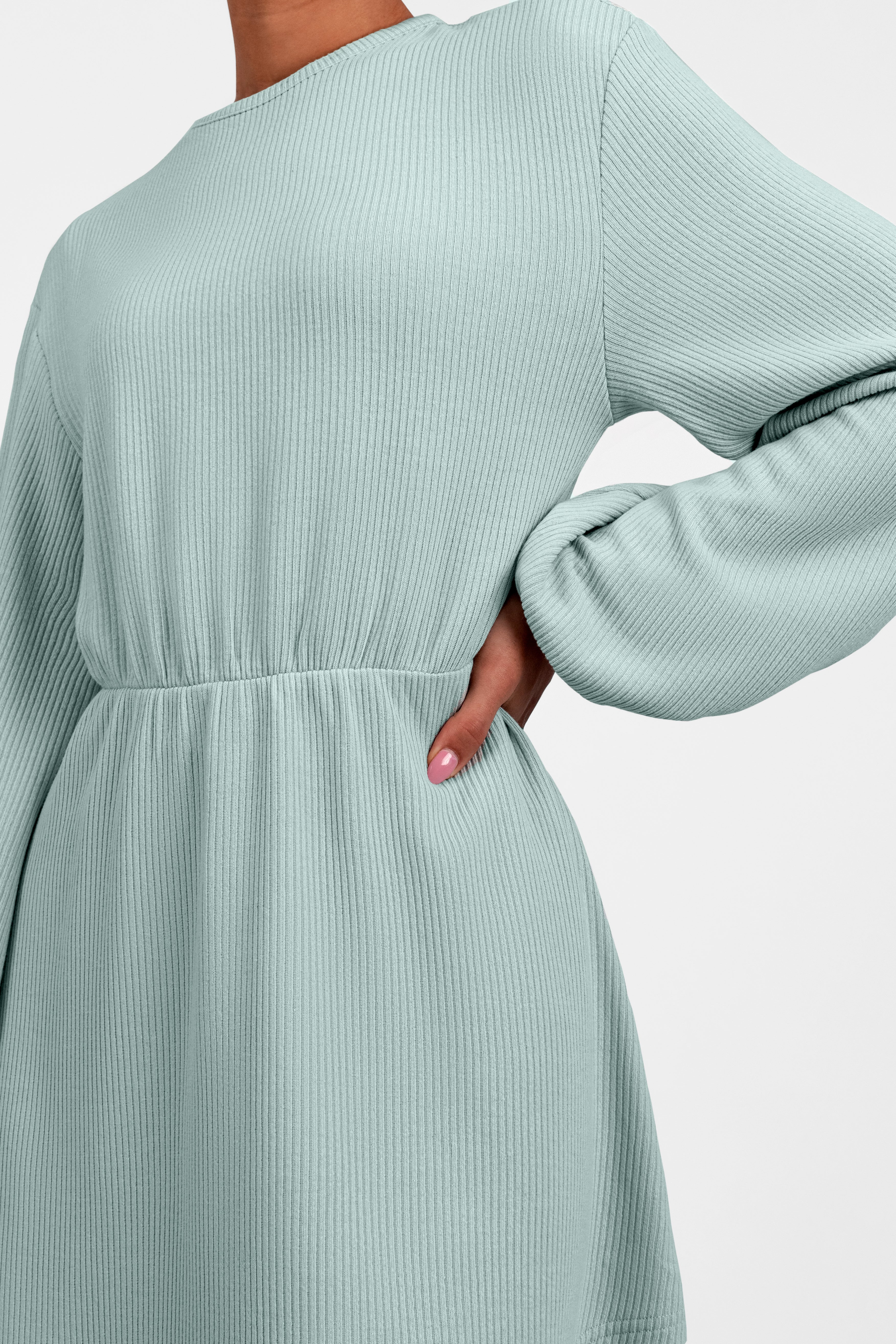 A close up of the Knit Peplum Top on a model.	Colour: Icy: Blue